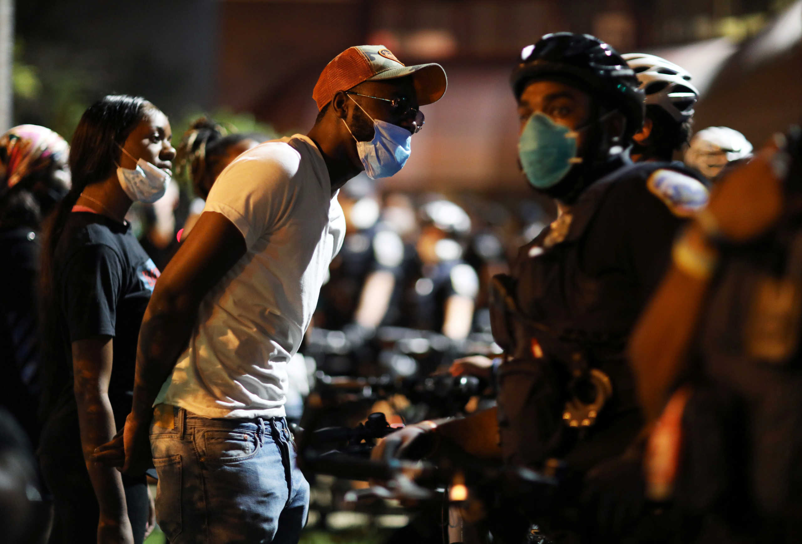 Protesters confront police officers outside of the 7th precinct to express their anger after Washington Metropolitan Police Department shot and killed a young black man in South East DC, U.S. September 2, 2020. REUTERS