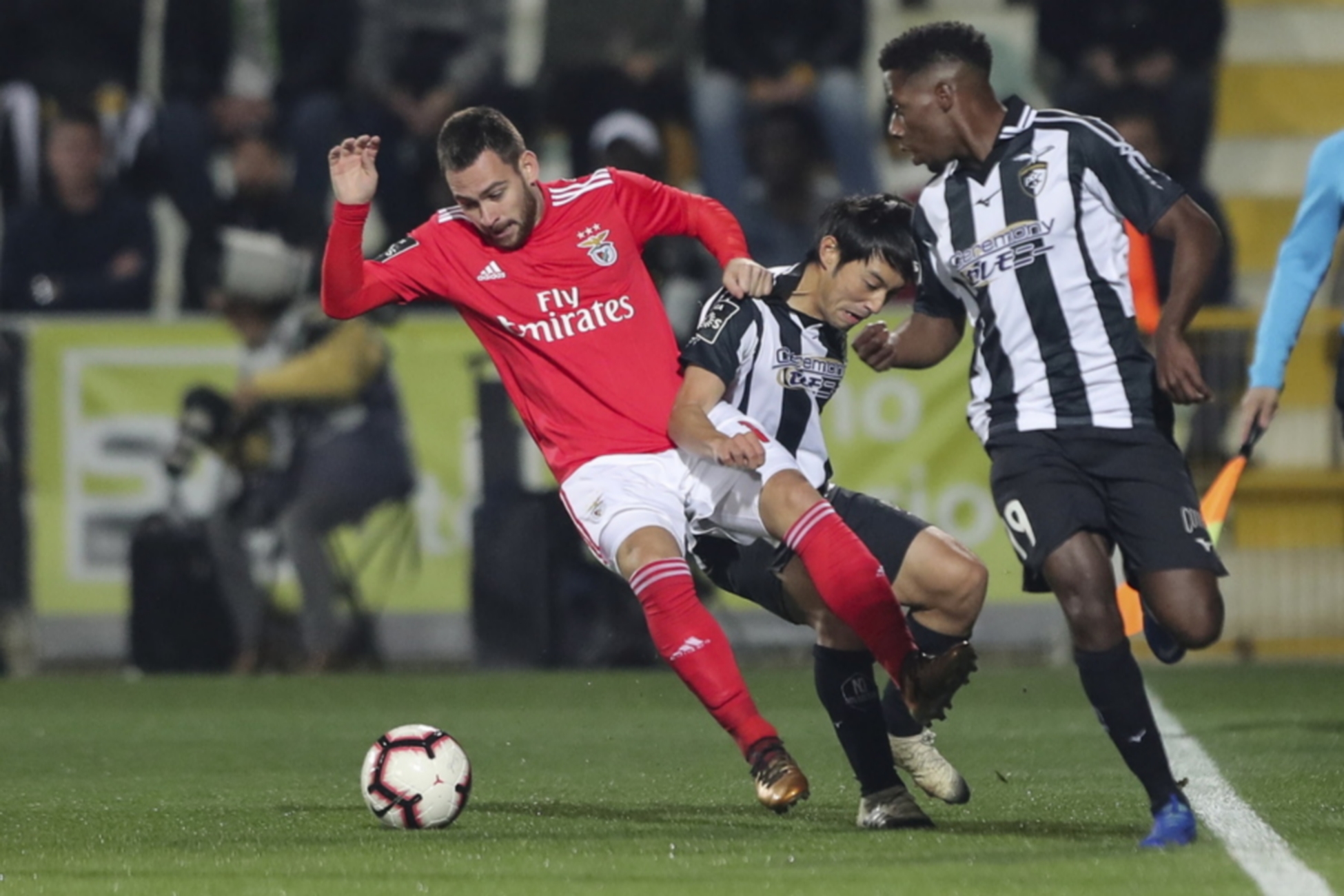 epa07258820 Manafa (R) and Shoya Nakajima (C) of Portimonense fight for the ball with Zivkovic of Benfica during their Portuguese First League soccer match held at Portimonense Stadium, Portimao, Portugal, 2nd January 2019.  EPA
