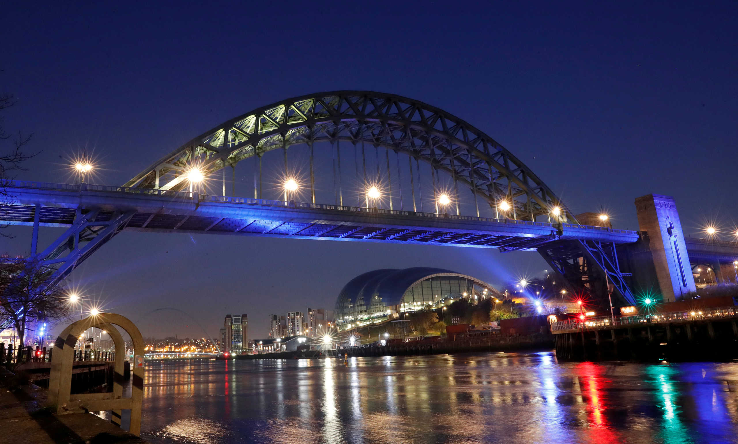 FILE PHOTO: General view as Tyne Bridge is lit blue in support of the NHS, as the spread of the coronavirus disease (COVID-19) continues, Newcastle upon Tyne, Britain, March 26, 2020. REUTERS