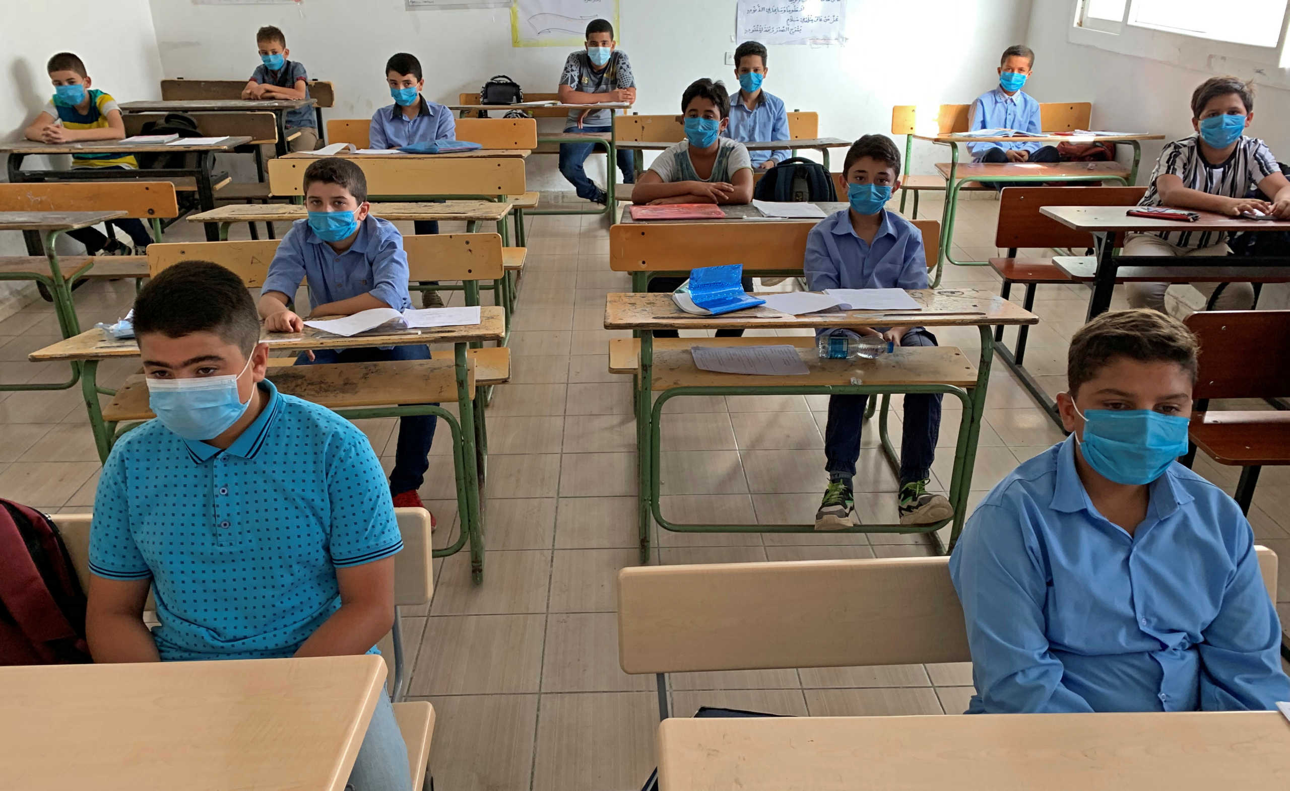 Students wearing protective face masks maintain social distancing as they attend a class after some schools reopened amid the coronavirus disease (COVID-19) crisis, in Misrata, Libya October 4, 2020. Picture taken October 4, 2020.  REUTERS
