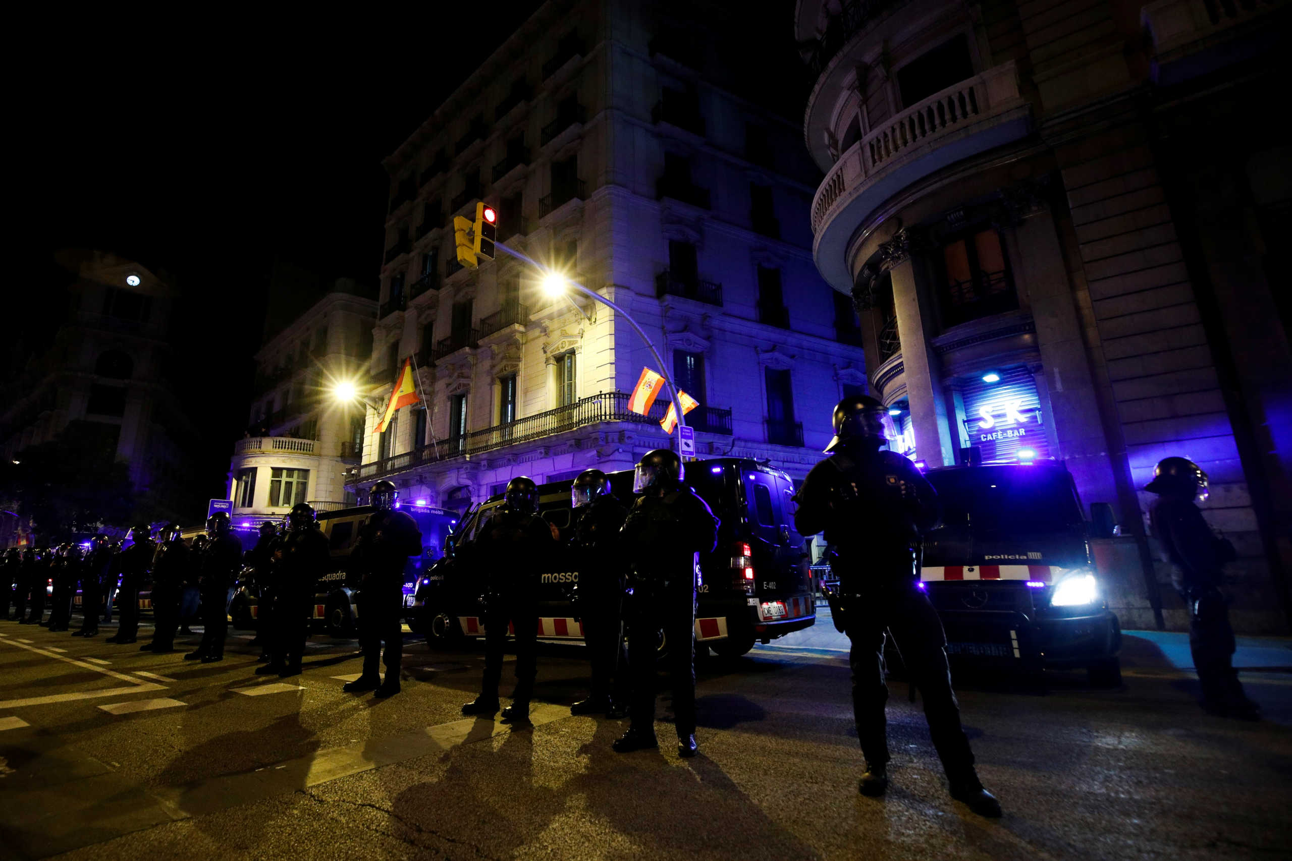 Police officers line up as Catalan separatists take part in a protest on first anniversary of sentencing of jailed leaders, in Barcelona, Spain, October 14, 2020. REUTERS