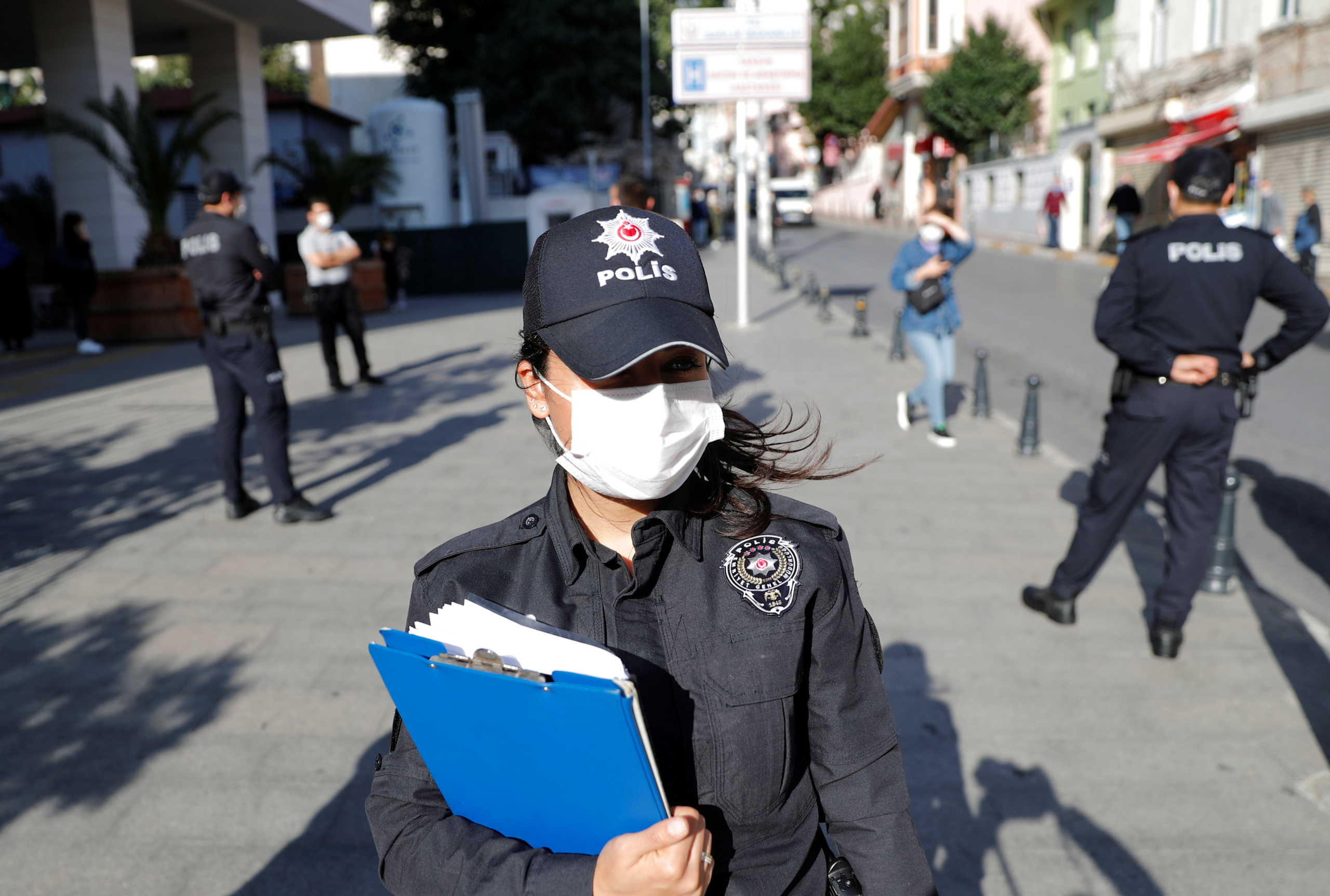 A police officer wearing a protective face mask checks if people wear them, as the coronavirus disease (COVID-19) outbreak continues, in Istanbul, Turkey October 21, 2020. REUTERS