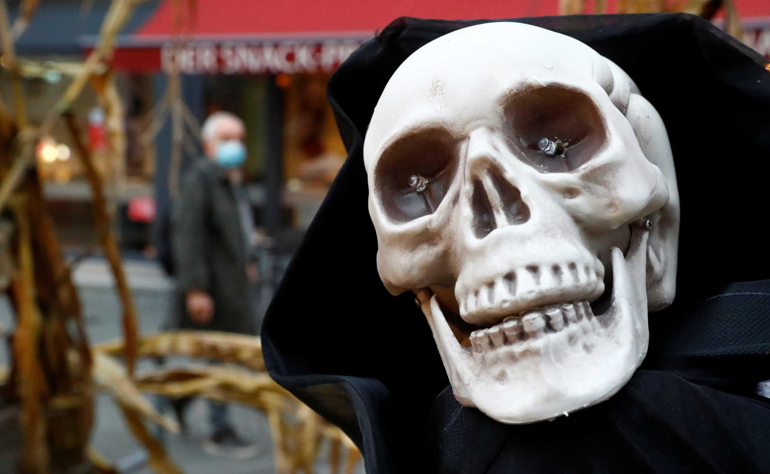 A mock up skull is seen ahead of Halloween at Wilmersdorfer Strasse shopping street, as the coronavirus disease (COVID-19) outbreak continues, in Berlin, Germany, October 26, 2020. REUTERS