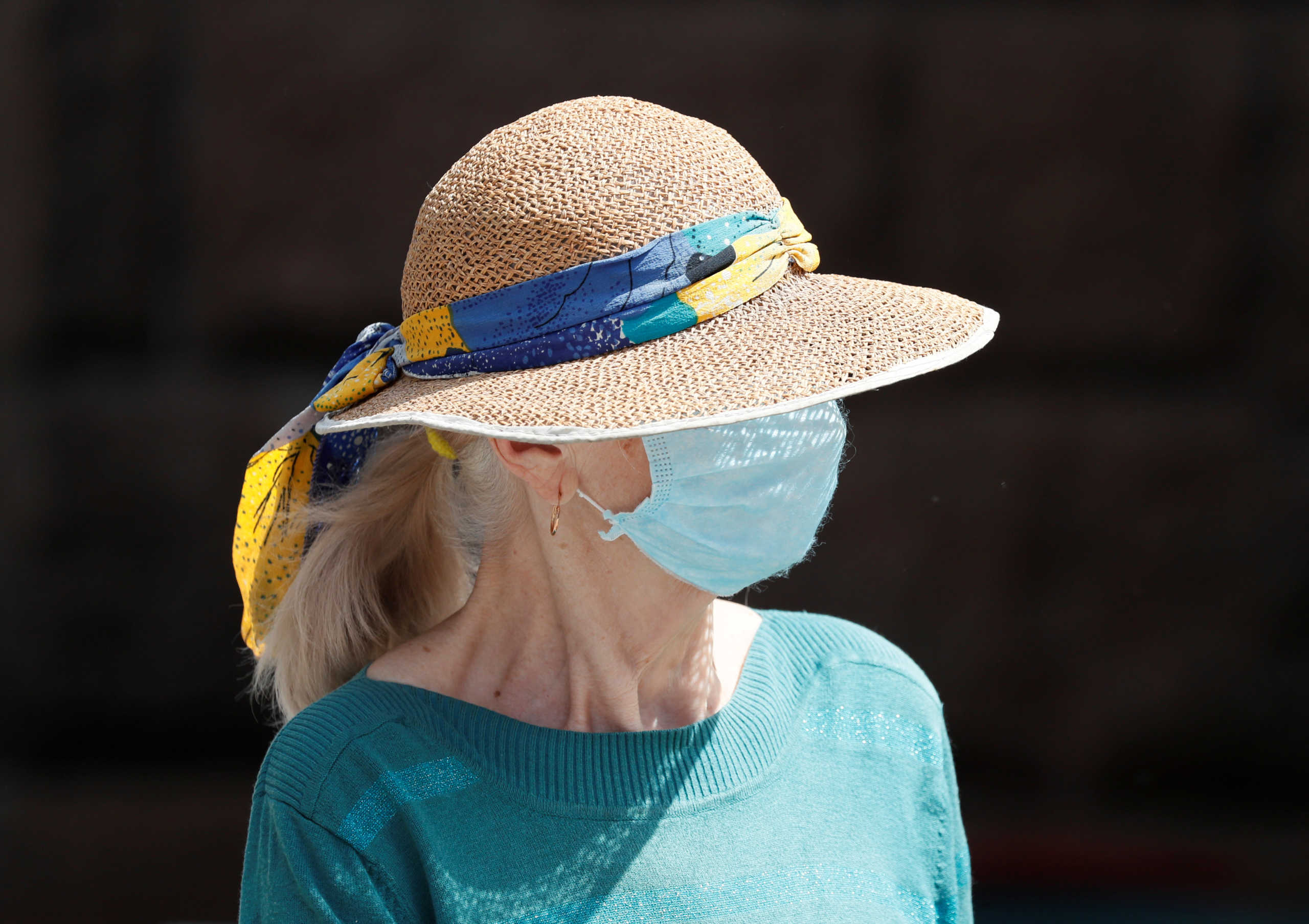 A woman wearing a protective face mask is seen on the street amid the outbreak of the coronavirus disease (COVID-19) in central Kiev, Ukraine June 9, 2020. REUTERS