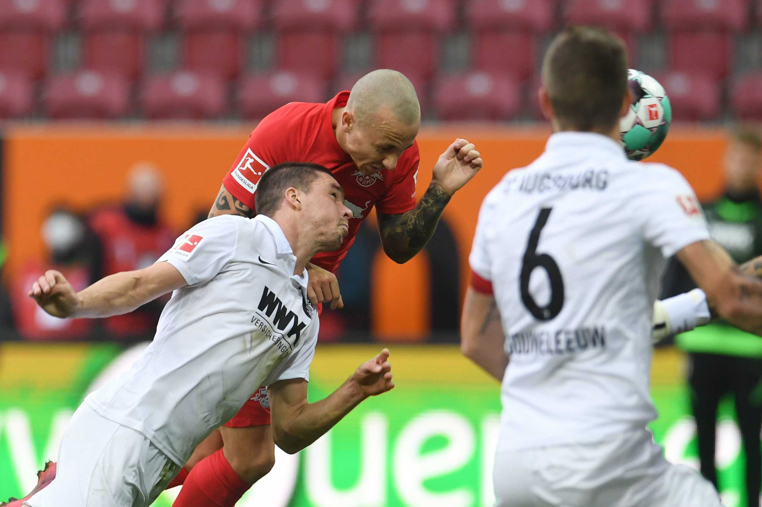 Soccer Football - Bundesliga - FC Augsburg v RB Leipzig - WWK Arena, Augsburg, Germany - October 17, 2020 RB Leipzig's Angelino in action with Augsburg's Raphael Framberger Pool via REUTERS
