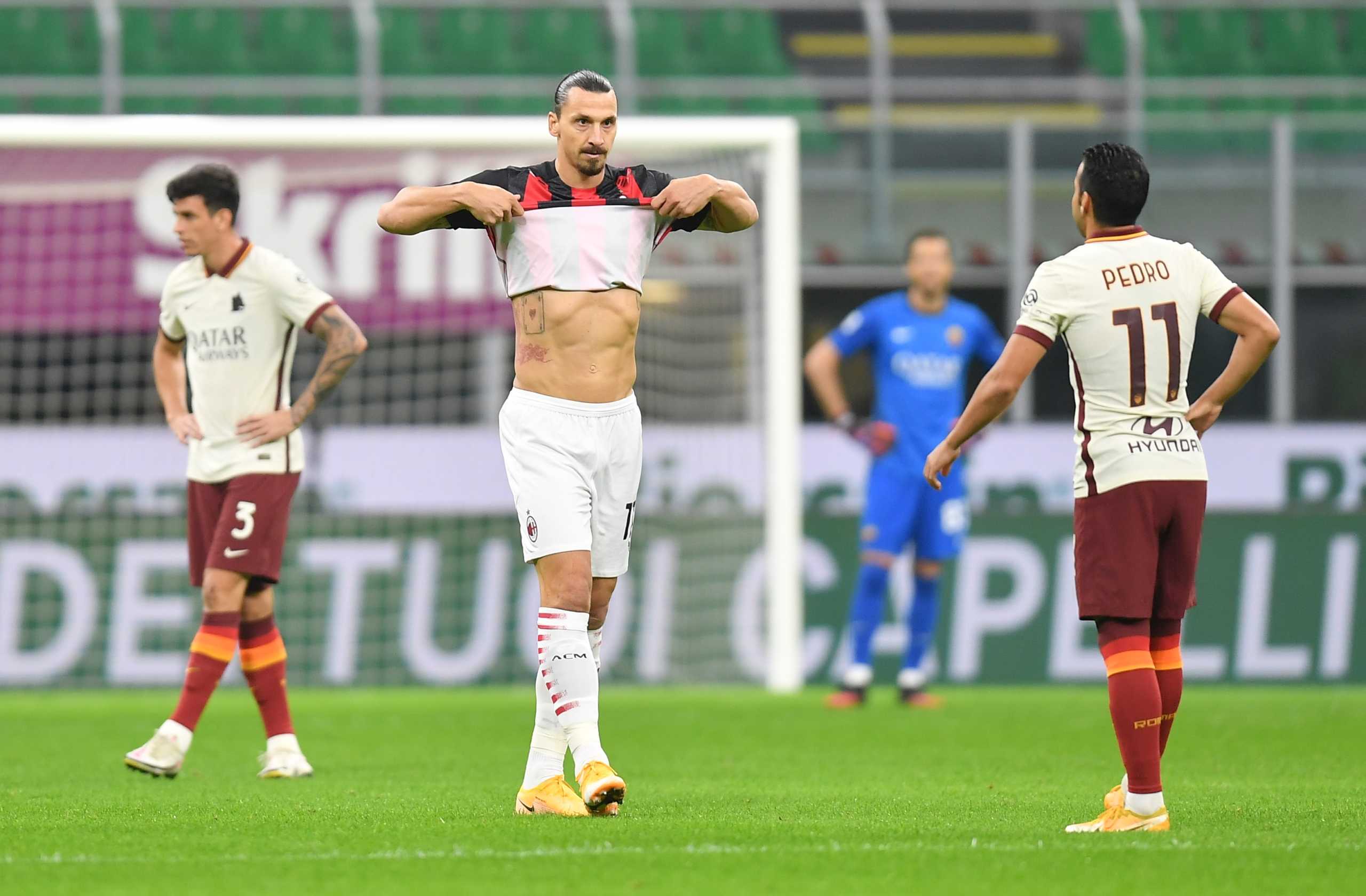Soccer Football - Serie A - AC Milan v AS Roma - San Siro, Milan, Italy - October 26, 2020 AC Milan’s Zlatan Ibrahimovic celebrates scoring their first goal alongside AS Roma’s Pedro REUTERS