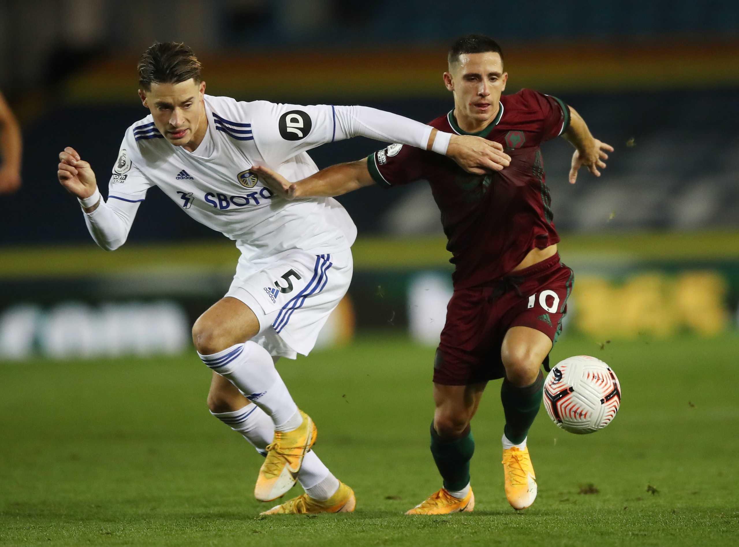 Soccer Football - Premier League - Leeds United v Wolverhampton Wanderers - Elland Road, Leeds, Britain - October 19, 2020 Wolverhampton Wanderers' Daniel Podence in action with Leeds United's Robin Koch Pool via REUTERS