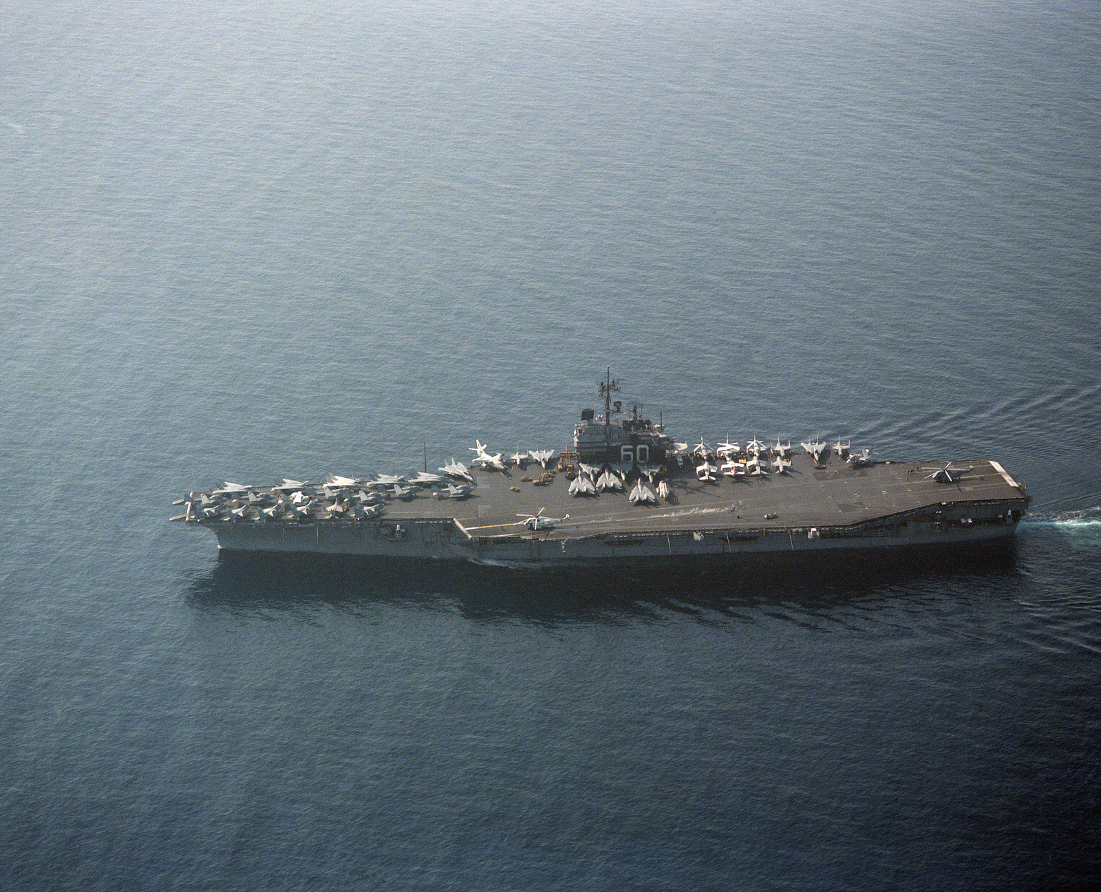 An elevated port beam view of the aircraft carrier USS SARATOGA (CV 60) underway.