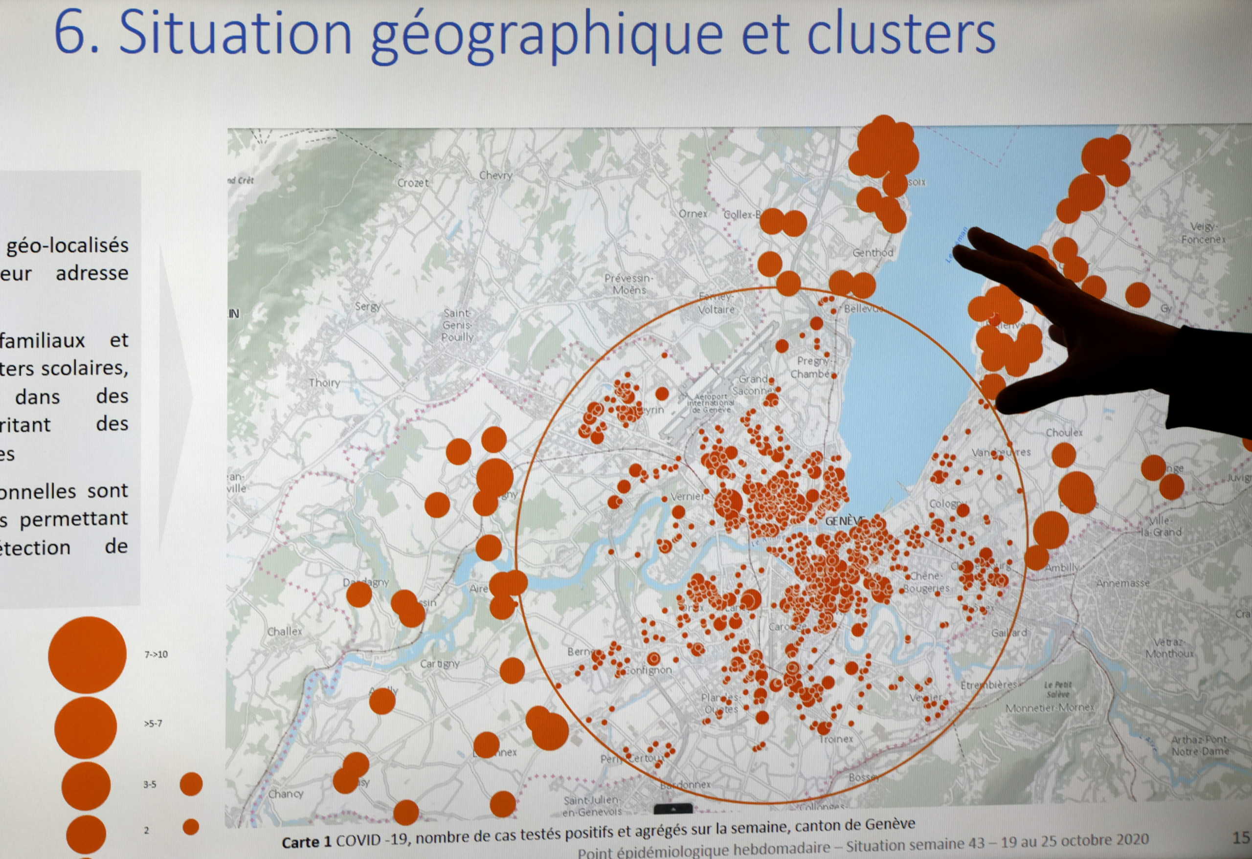 A County of Geneva staff member shows the geographical spread of clusters during an update briefing in the contact tracing unit, as Switzerland enters a second wave of coronavirus disease (COVID-19) outbreak, in Geneva, Switzerland, October 29, 2020. REUTERS
