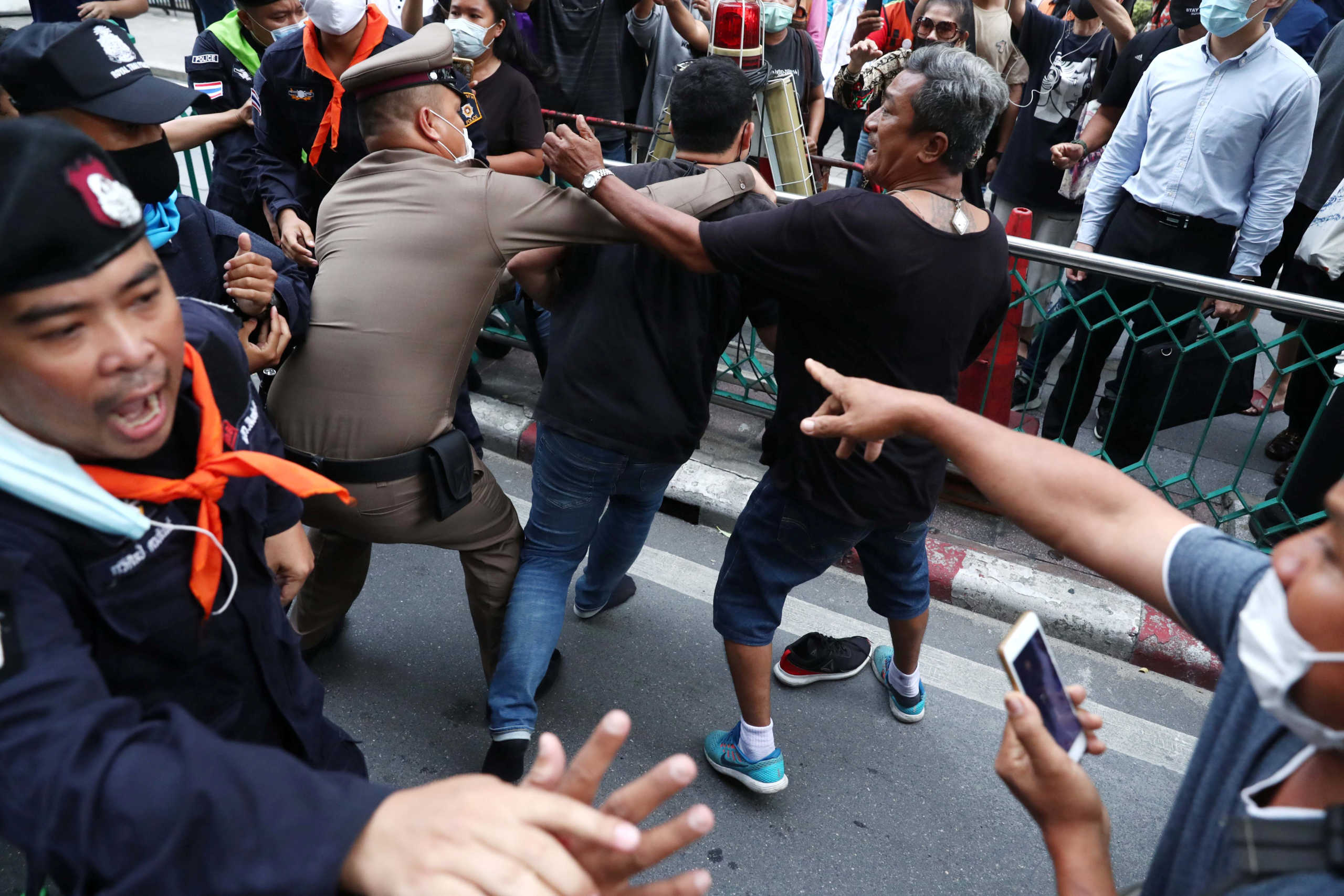 Pro-democracy protesters scuffle with police officers as they gather demanding the government to resign and to release detained leaders in Bangkok, Thailand October 15, 2020. REUTERS
