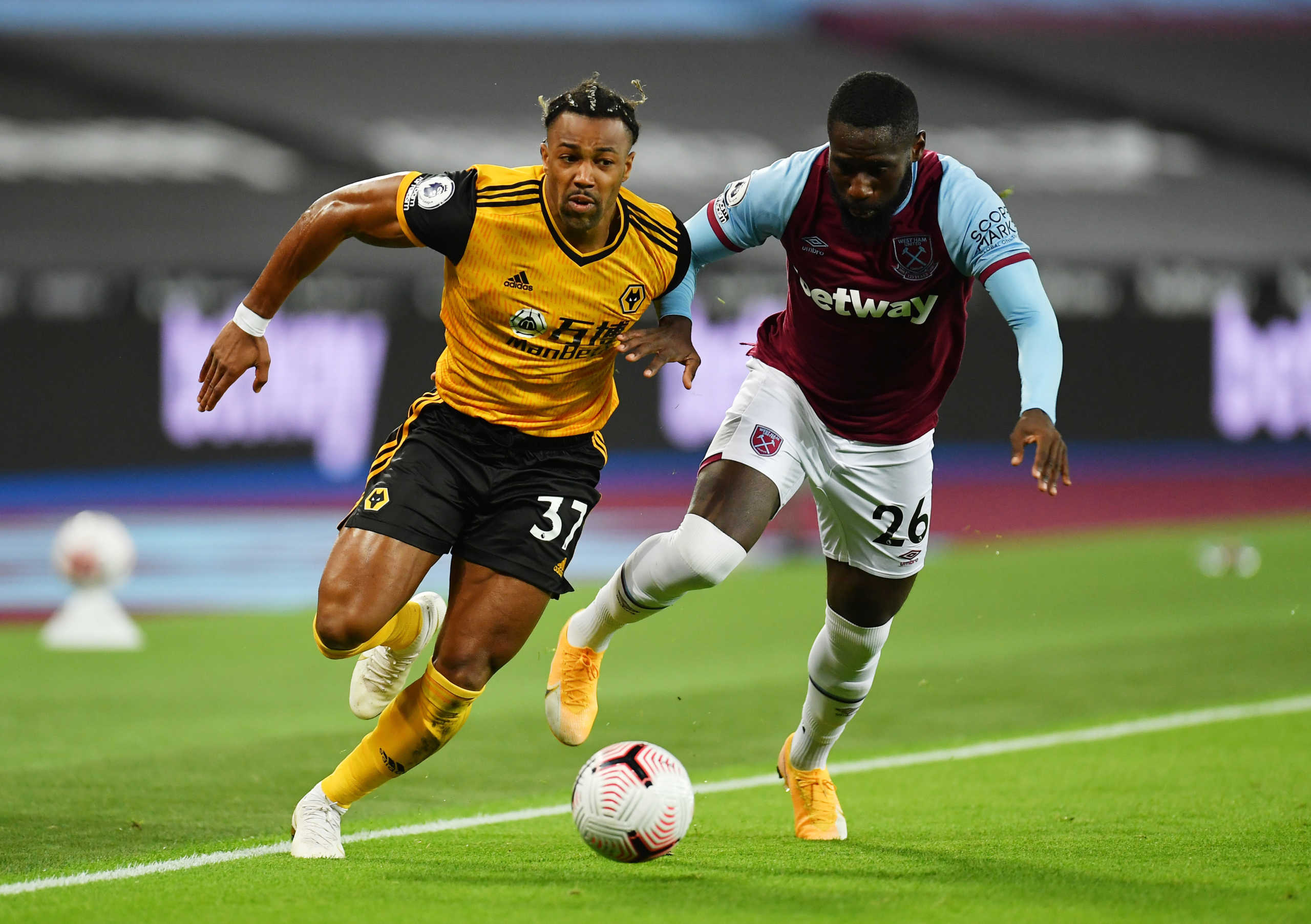 Soccer Football - Premier League - West Ham United v Wolverhampton Wanderers - London Stadium, London, Britain - September 27, 2020. West Ham United's Arthur Masuaku in action with Wolverhampton Wanderers' Adama Traore. Pool via REUTERS