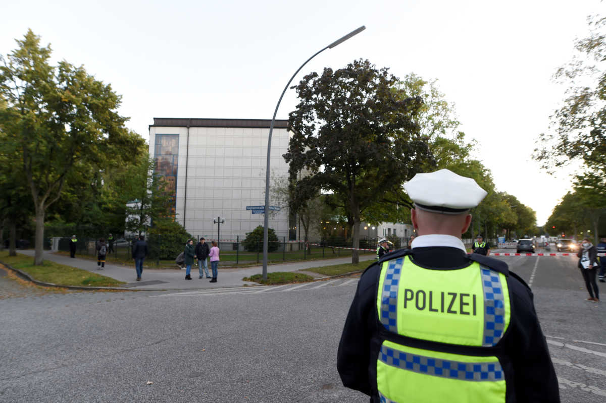Police members secure the area where a Jewish man was attacked, in front of the Hamburg synagogue, Hamburg, Germany October 4, 2020. REUTERS