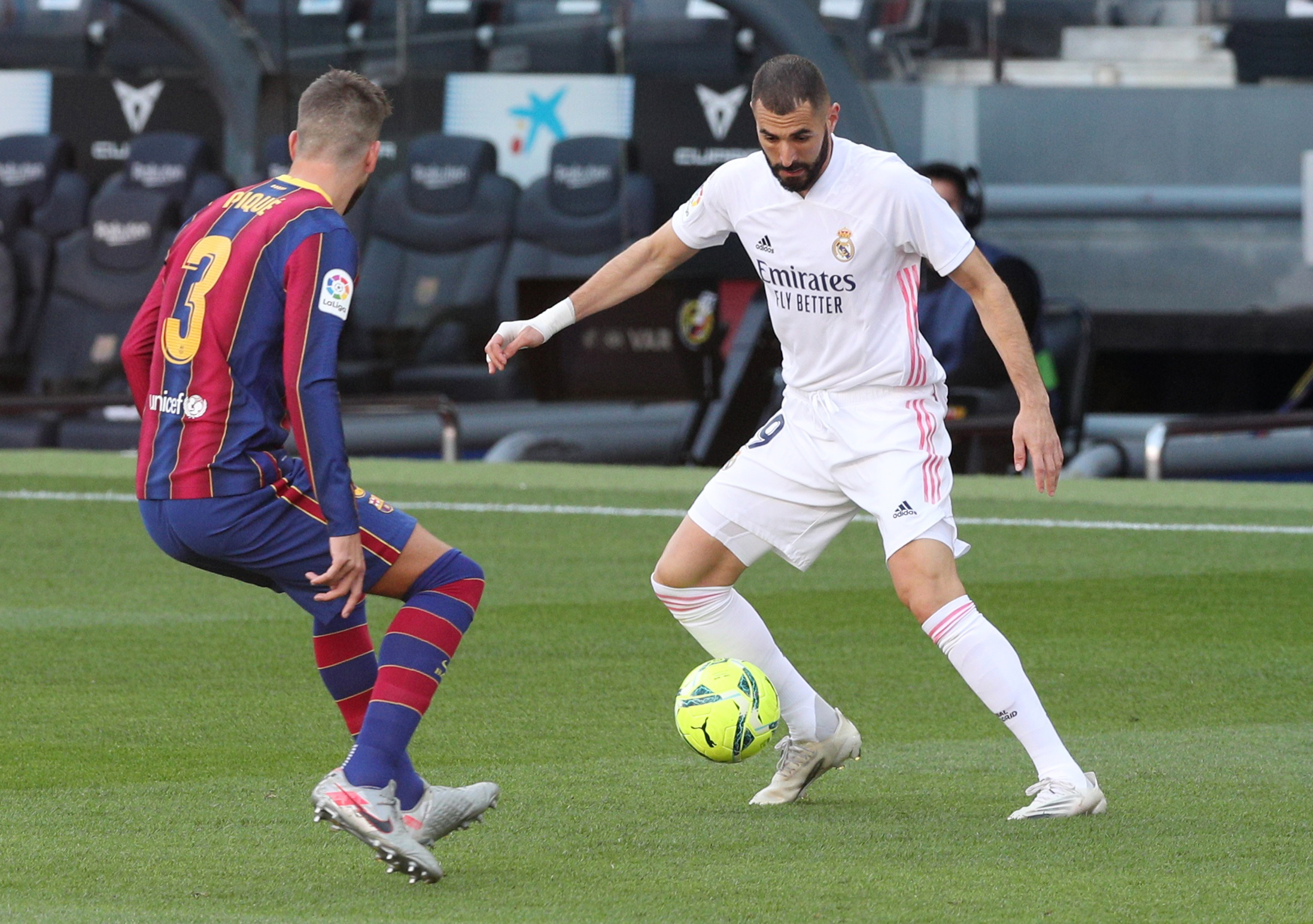 Soccer Football - La Liga Santander - FC Barcelona v Real Madrid - Camp Nou, Barcelona, Spain - October 24, 2020 Real Madrid's Karim Benzema in action with Barcelona's Gerard Pique REUTERS