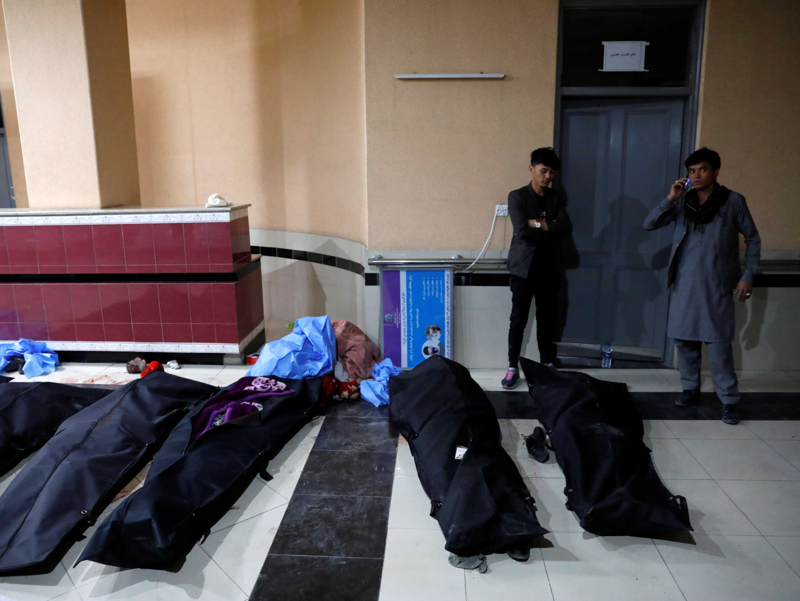 Afghan men look for their relatives at a hospital after a suicide bombing in Kabul, Afghanistan October 24, 2020. REUTERS