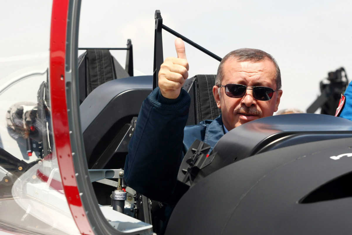 Turkish Prime Minister Recep Tayyip Erdogan gives a thumbs-up sign from the cockpit of the Turkish Primary and Basic Trainer Aircraft "Hurkus" during a ceremony at the Turkish Aerospace Industries in Ankara June 27, 2012.  AFP PHOTO