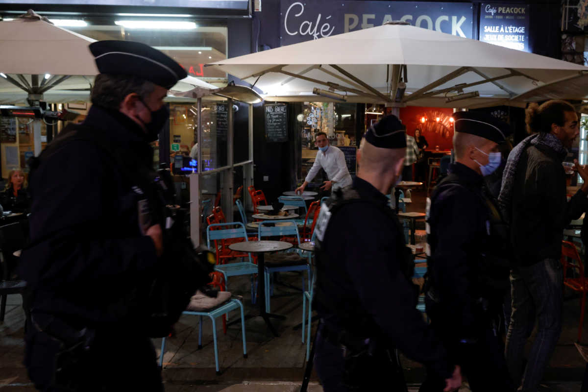 FILE PHOTO: Police officers patrol near bars and restaurants as people attend a protest against the new sanitary measures by the French government to stop a second wave of the coronavirus disease (COVID-19), in Lille, France, September 29, 2020. REUTERS