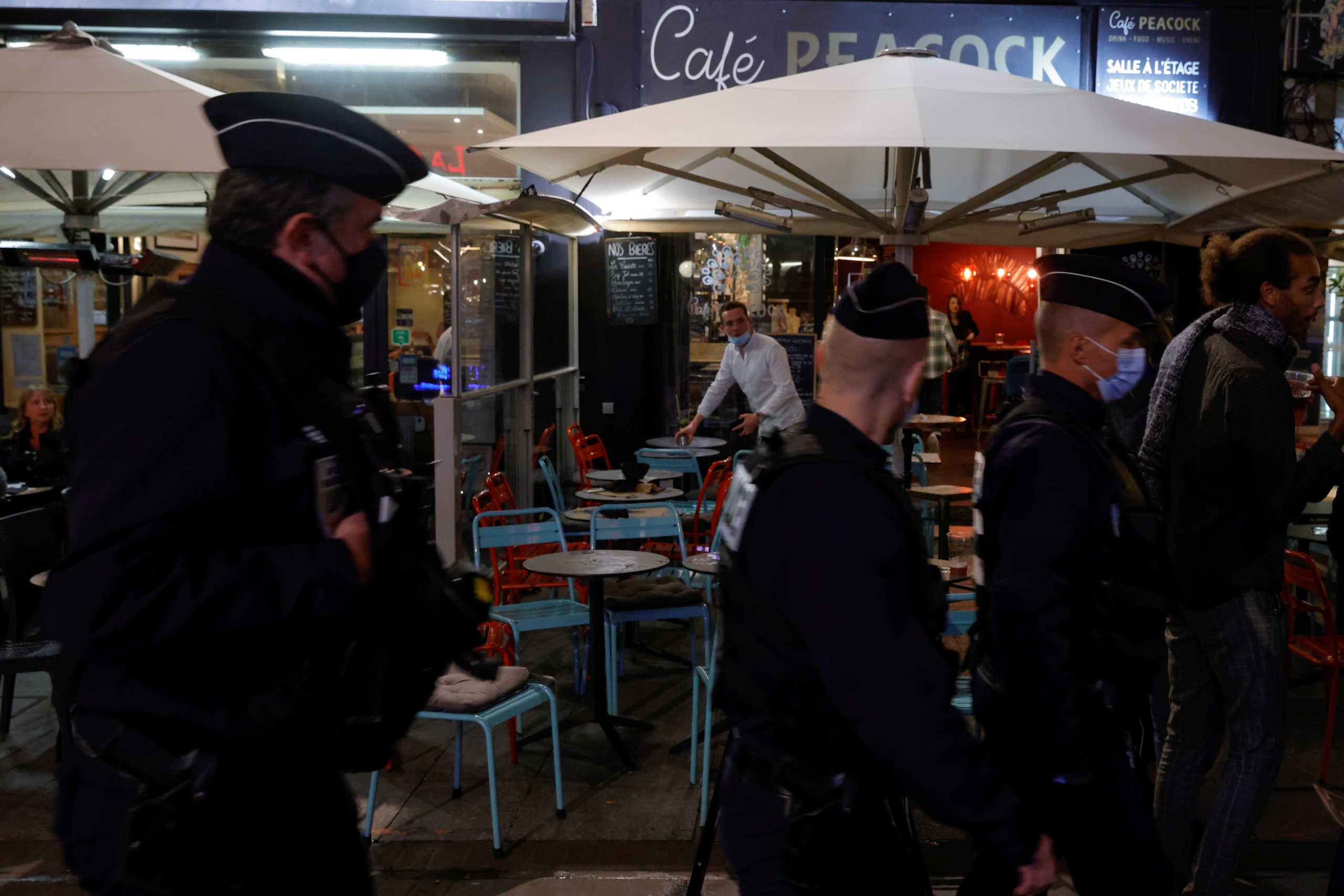 FILE PHOTO: Police officers patrol near bars and restaurants as people attend a protest against the new sanitary measures by the French government to stop a second wave of the coronavirus disease (COVID-19), in Lille, France, September 29, 2020. REUTERS