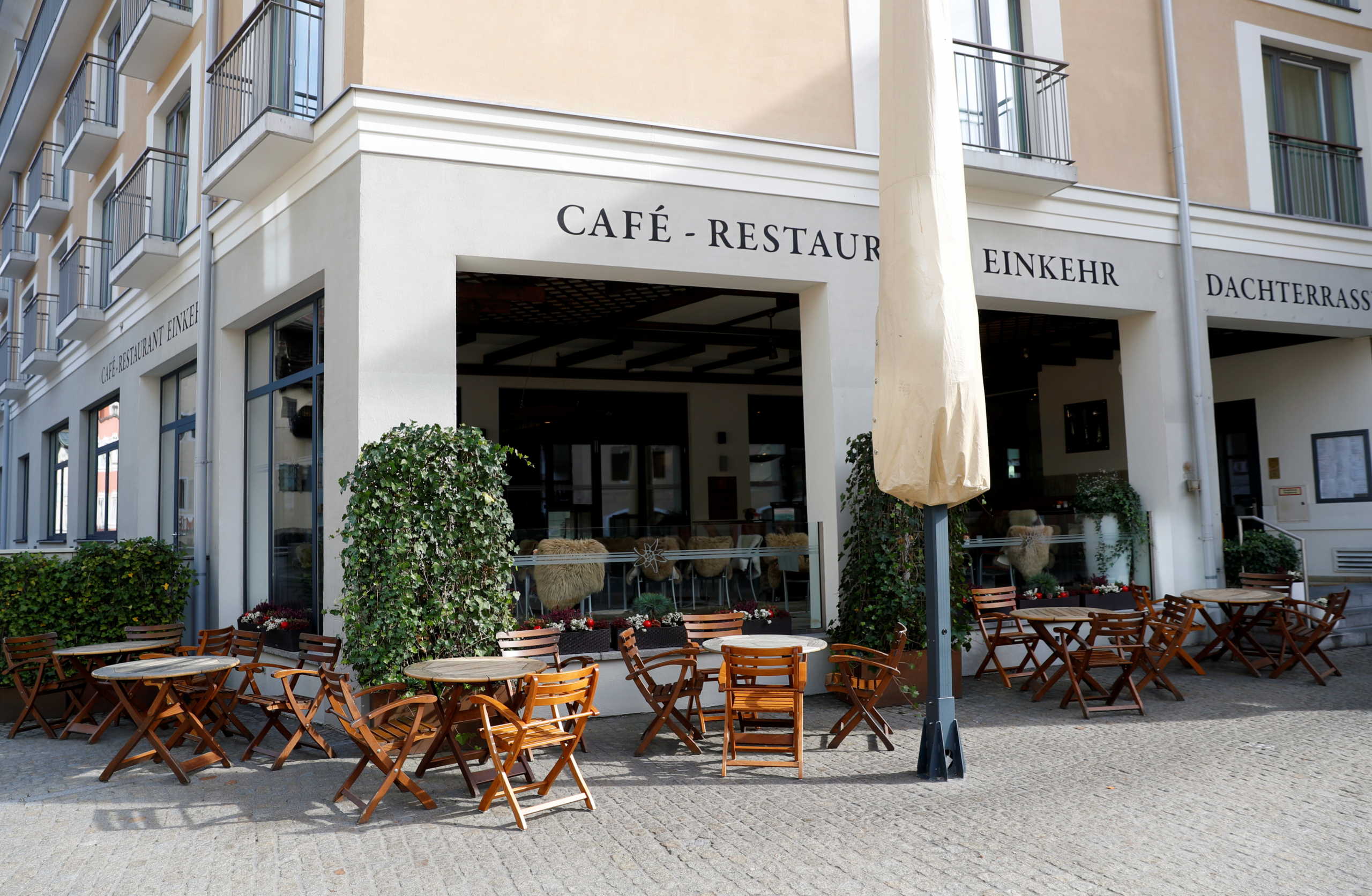 Empty chairs are pictured outside a restaurant, after residents of the Berchtesgadener Land district of Bavaria will not be able to leave their homes from October 20, 2020, without a valid reason for two weeks, making it the first area in Germany to go back into lockdown since April, in the city of Berchtesgaden, Germany October 20, 2020. REUTERS