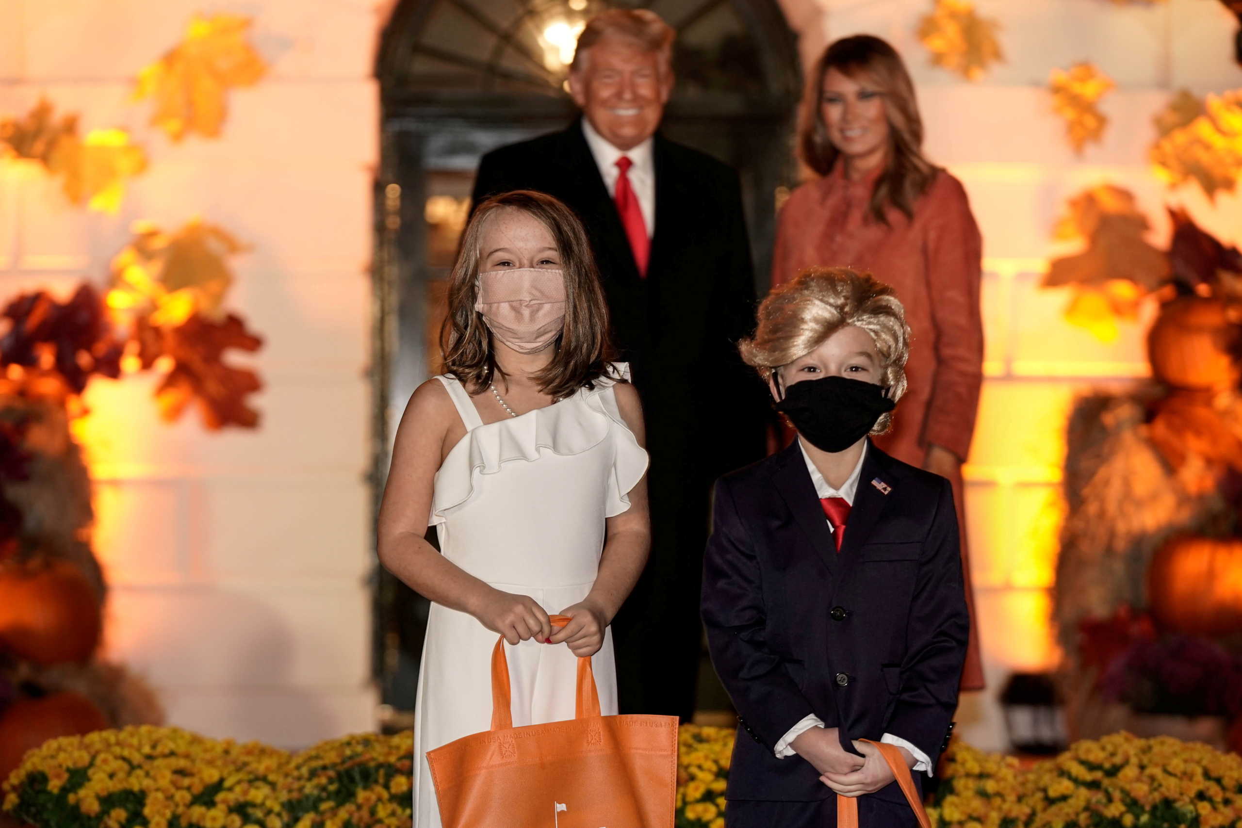 Children dressed as U.S. President Donald Trump and U.S. first lady Melania Trump attend a Halloween event hosted by President Trump and the first lady at the White House in Washington, U.S.,October 25, 2020. REUTERS