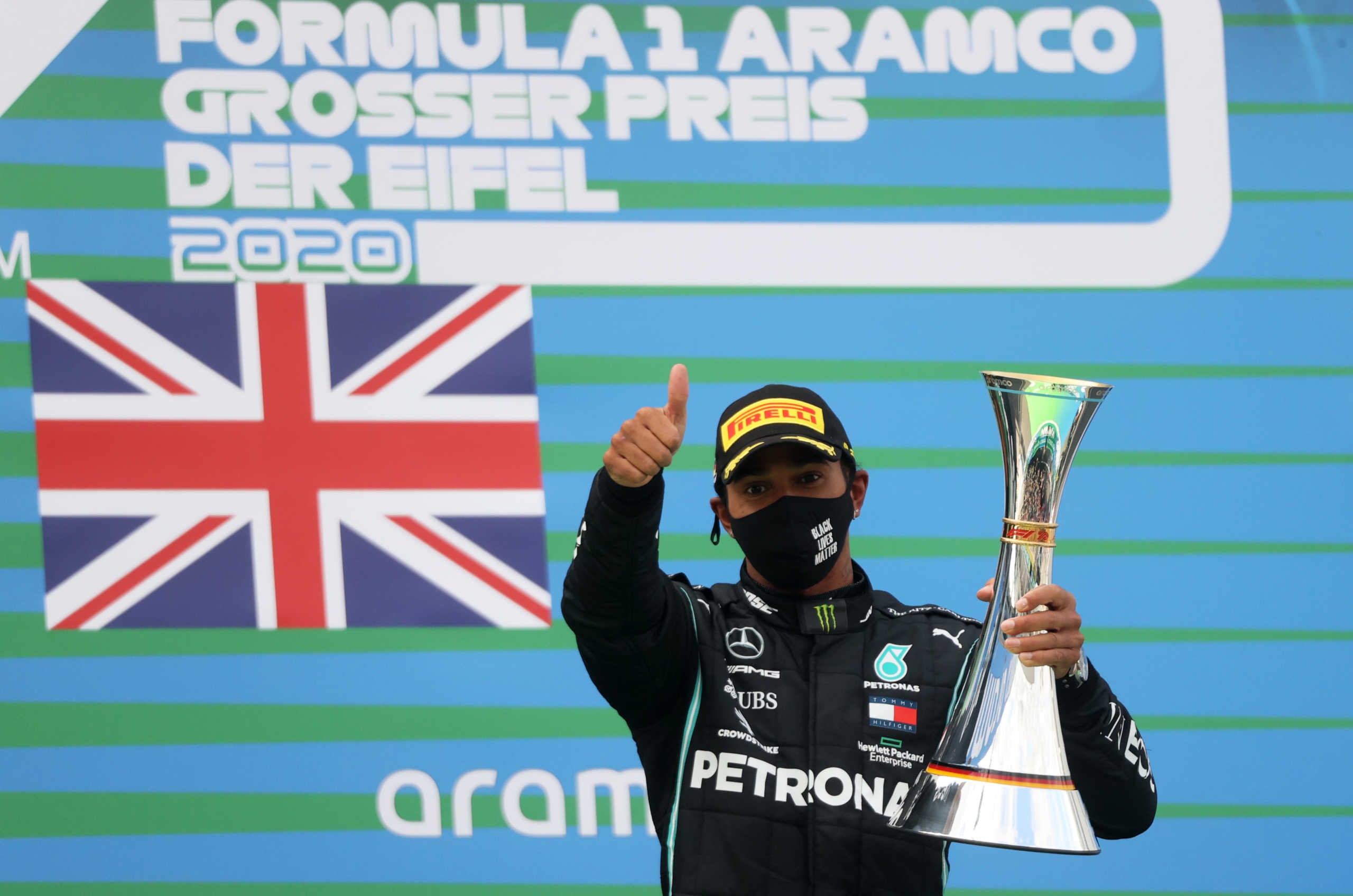 Formula One F1 - Eifel Grand Prix - Nurburgring, Nurburg, Germany - October 11, 2020 Mercedes' Lewis Hamilton celebrates with a trophy on the podium after winning the race Pool via REUTERS