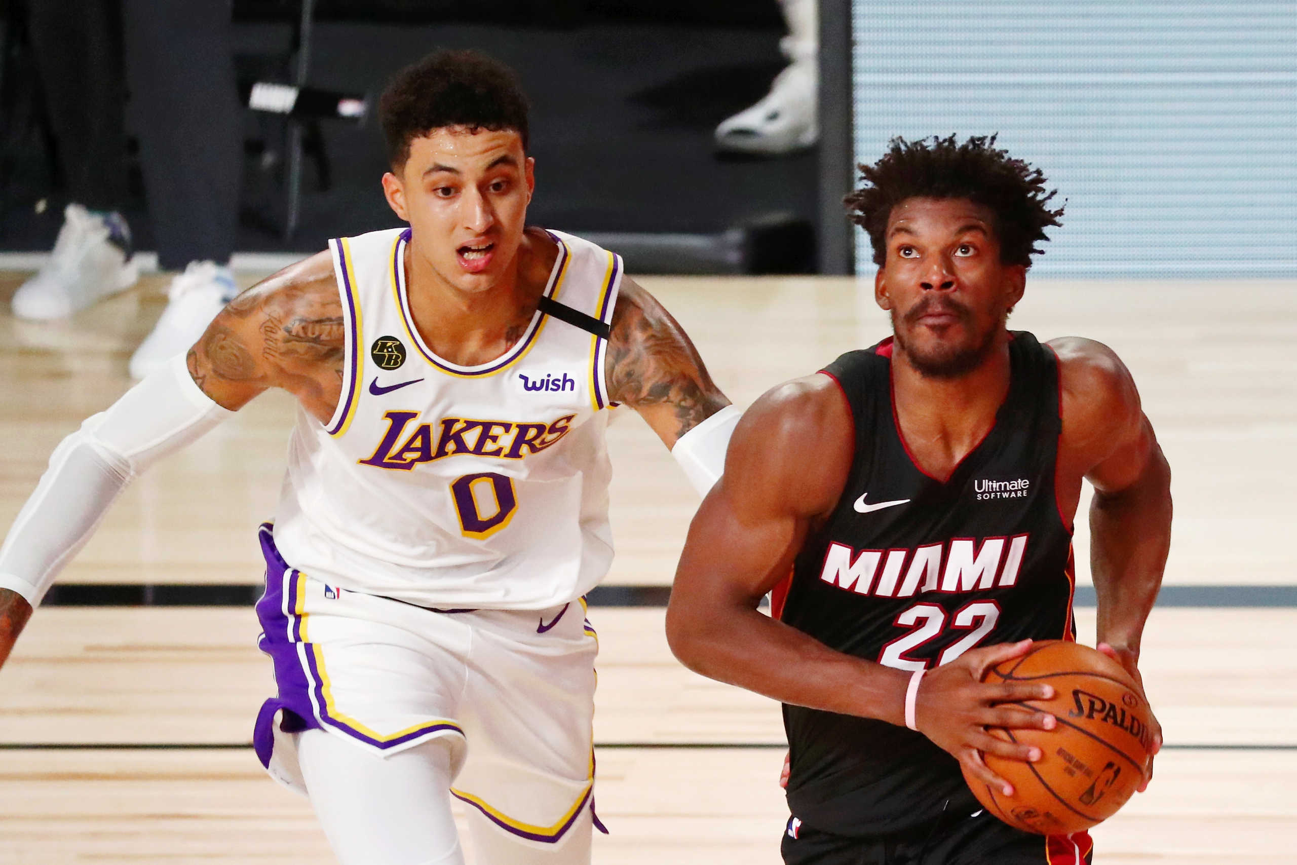 Oct 4, 2020; Orlando, Florida, USA; Miami Heat forward Jimmy Butler (22) drives to the basket as Los Angeles Lakers forward Kyle Kuzma (0) pursues during the fourth quarter of game three of the 2020 NBA Finals at AdventHealth Arena. The Miami Heat won 115-104. Mandatory Credit: Kim Klement-USA TODAY Sports