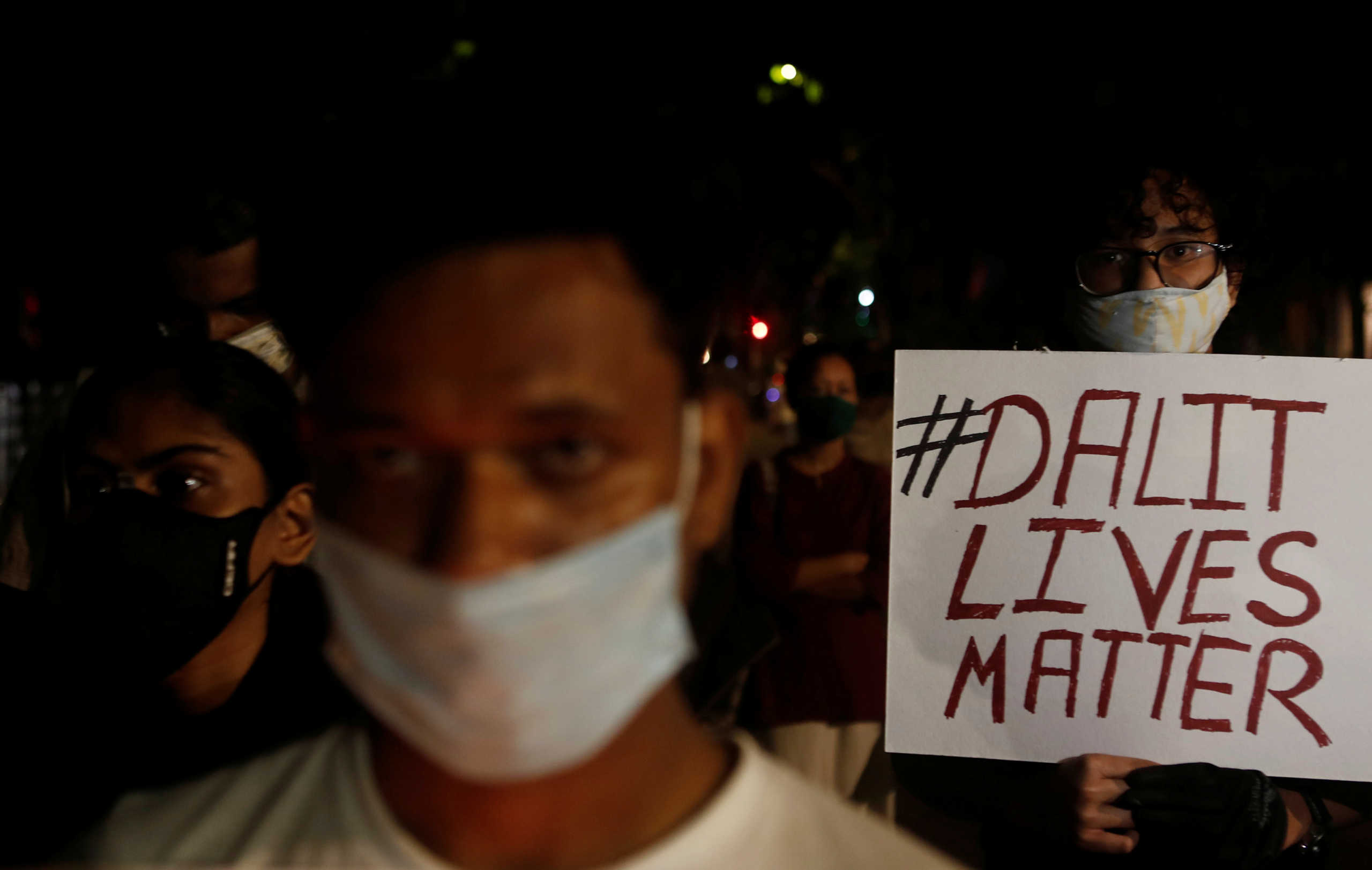 A man holds a placard during a protest after the death of a rape victim, on a street in Mumbai, India, September 30, 2020. REUTERS