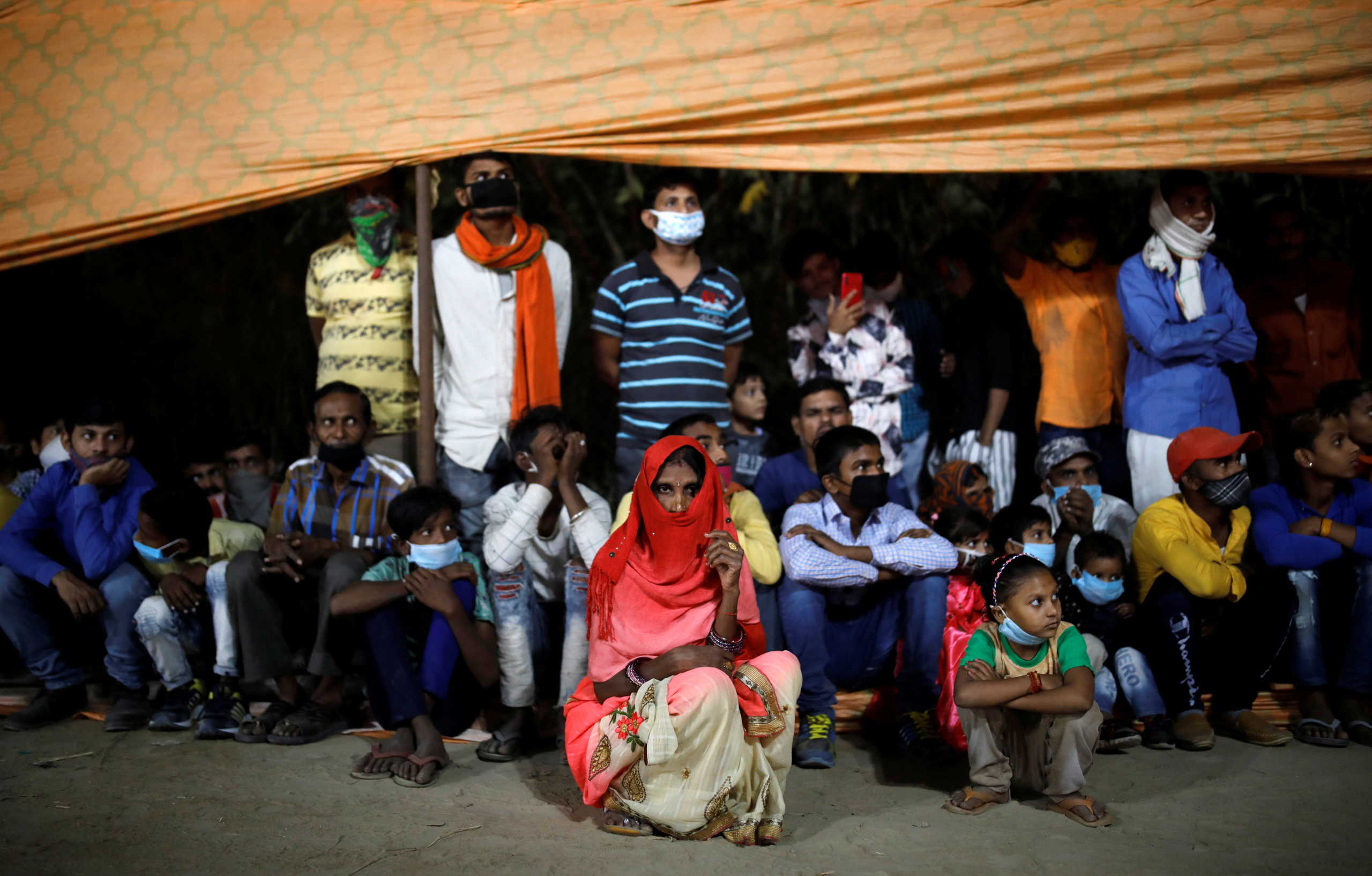 People watch Ramlila, an re-enactment of the life of Hindu Lord Rama, during Dussehra festival celebrations amidst the spread of the coronavirus disease (COVID-19) in New Delhi, October 25, 2020. REUTERS