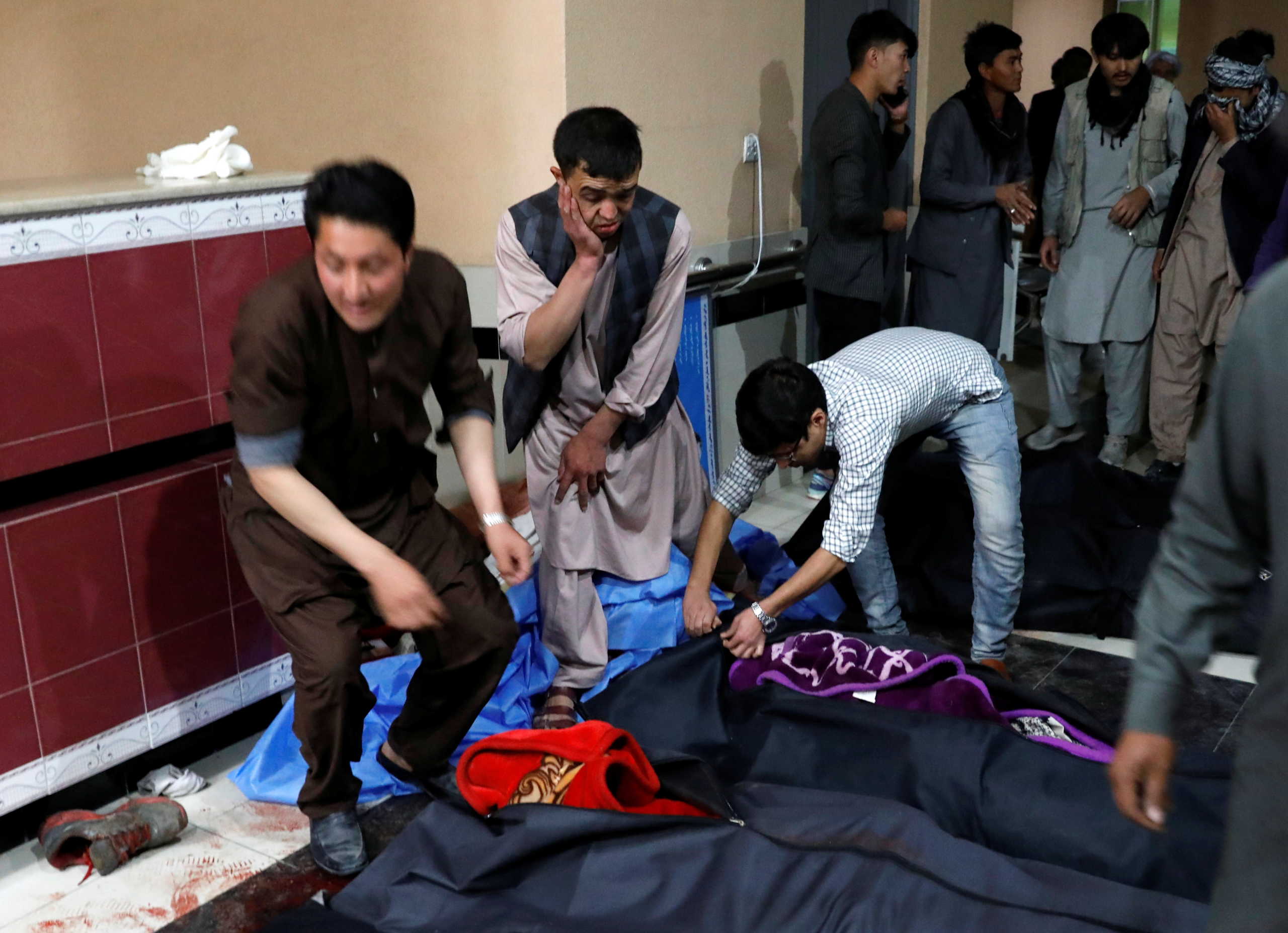 Afghan men look for their relatives at a hospital after a suicide bombing in Kabul, Afghanistan October 24, 2020. REUTERS