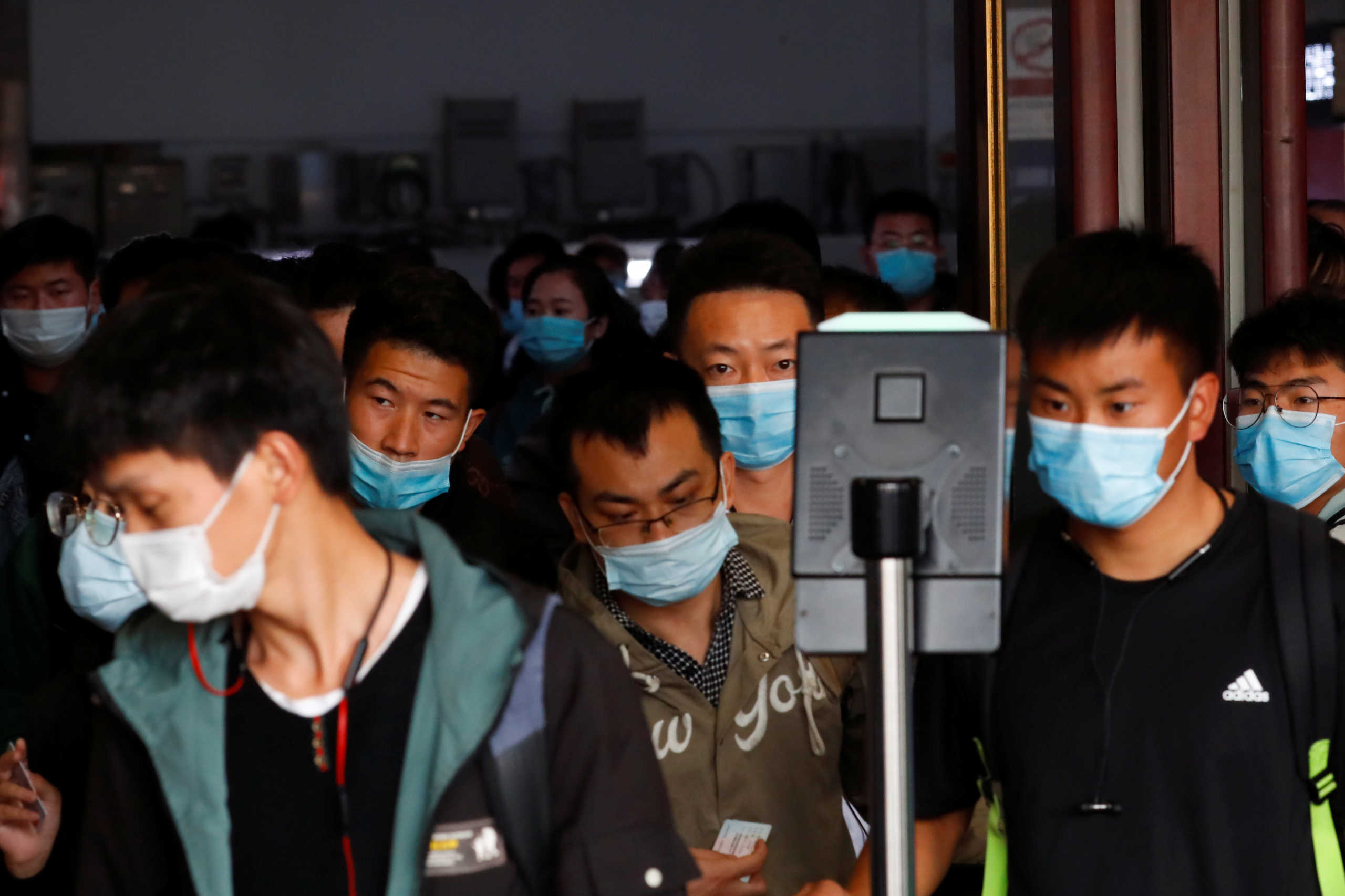 People arrive at Beijing Railway Station after an eight-day National Day holiday following the outbreak of the coronavirus disease (COVID-19) in Beijing, China, October 9, 2020. REUTERS