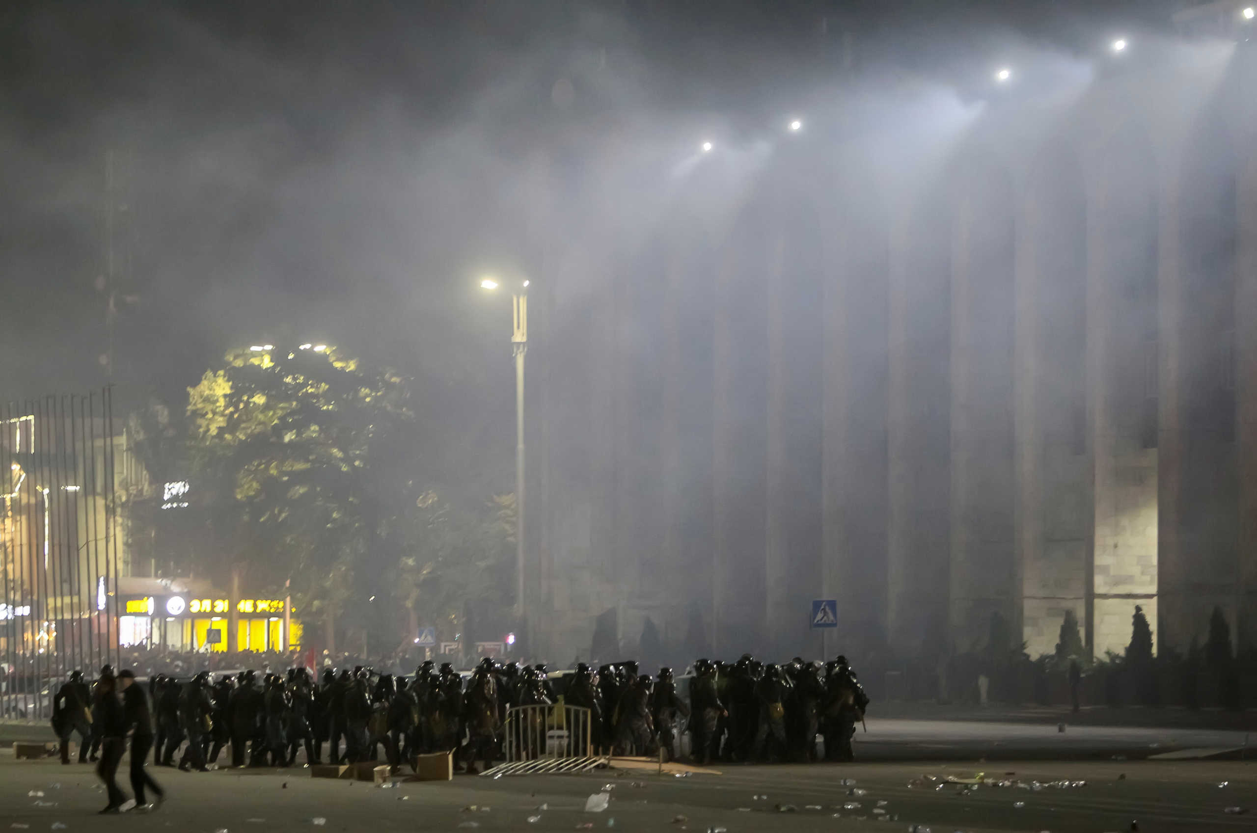 Police officers are seen in clouds of tear gas as they disperse protesters during a rally against the result of a parliamentary election in Bishkek, Kyrgyzstan, October 5, 2020.  REUTERS