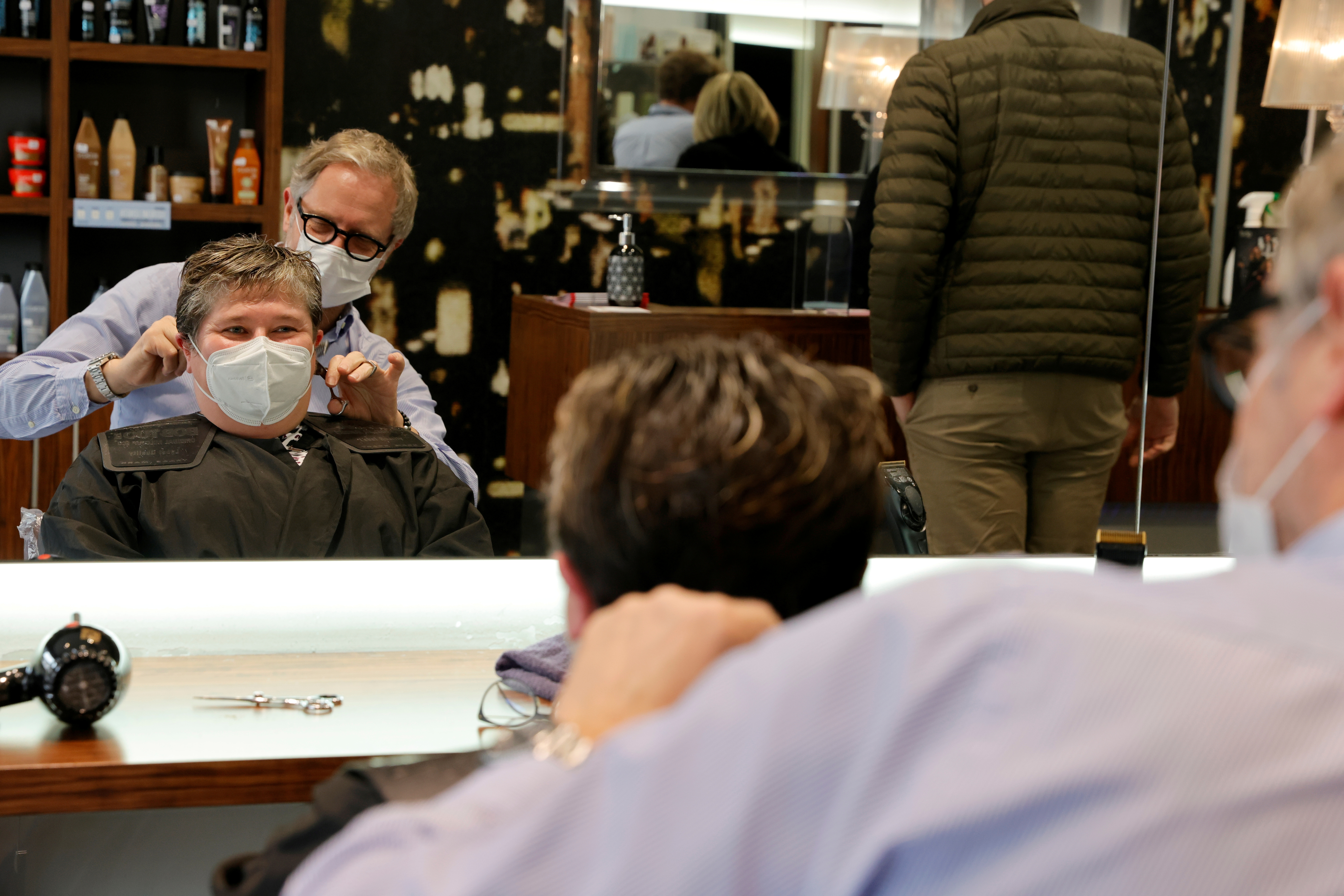 A hairdresser works in his shop in Cambrai a few hours before introducing a new lockdown as a second wave of the coronavirus disease sweeps France, October 29, 2020. REUTERS