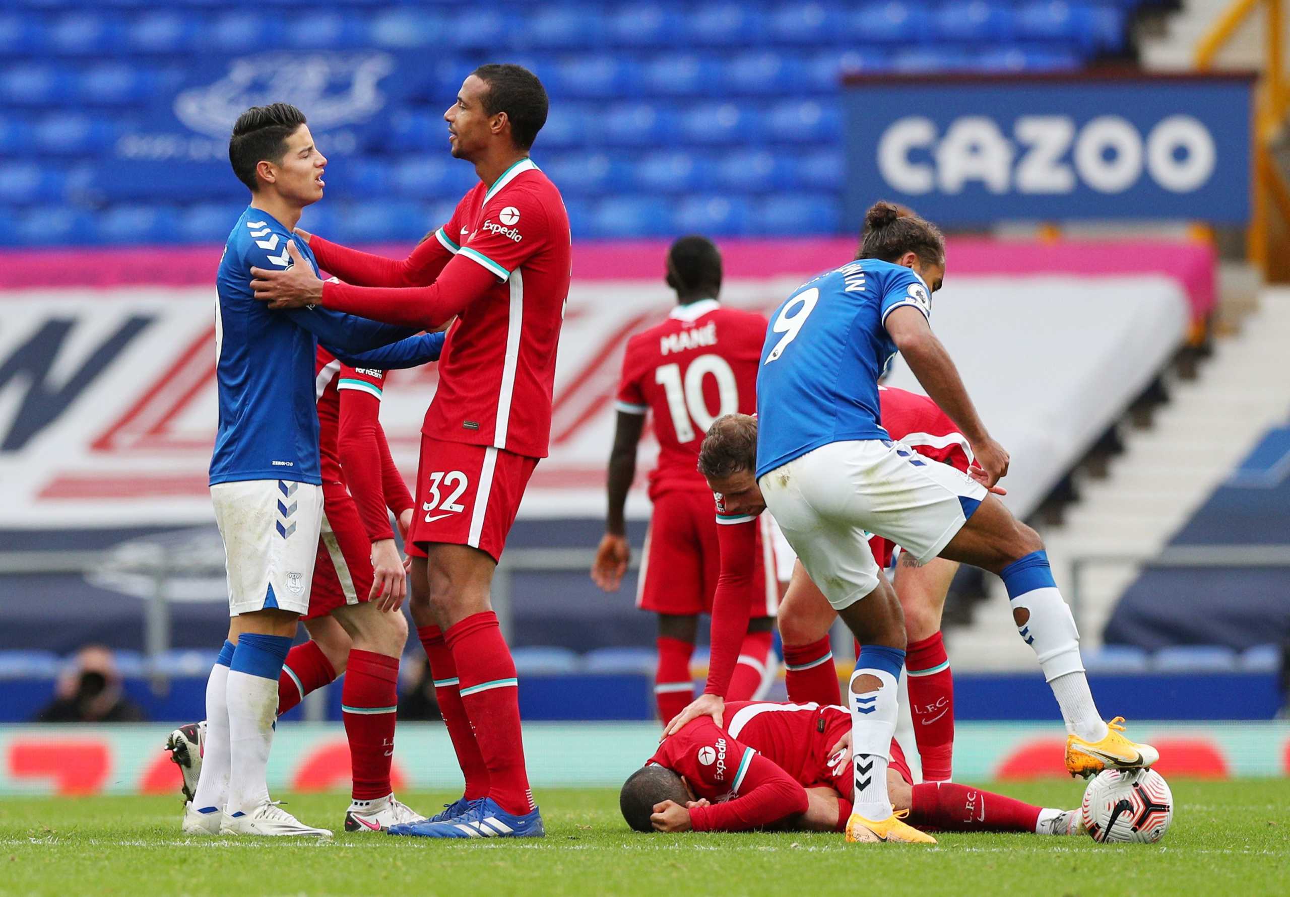 Soccer Football - Premier League - Everton v Liverpool - Goodison Park, Liverpool, Britain - October 17, 2020  Everton's James Rodriguez and Liverpool's Joel Matip clash as Liverpool's Thiago Alcantara lies on the ground after sustaining an injury after being challenged by Everton's Richarlison resulting in Richarlison being sent off Pool via REUTERS