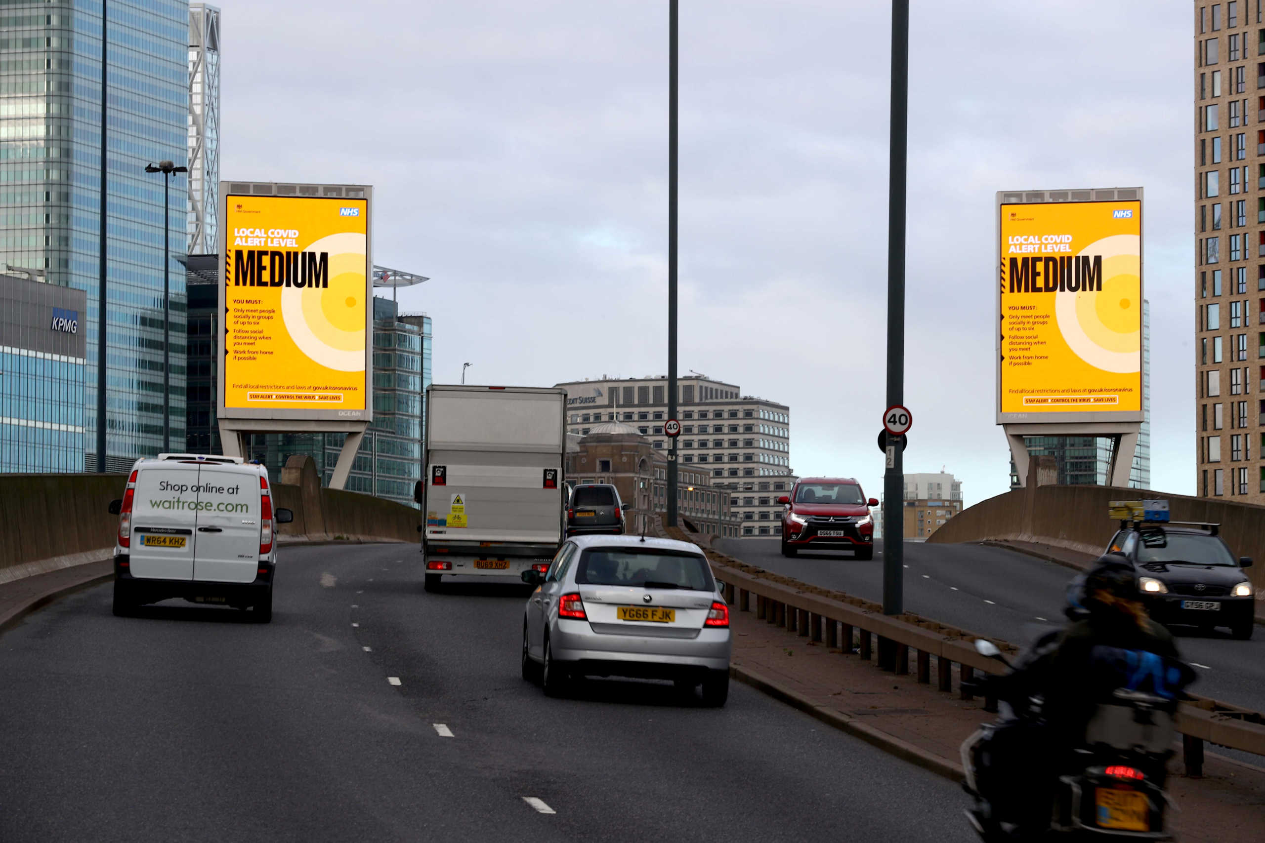 Government local COVID-19 alert level signs are pictured amid the outbreak of the coronavirus disease (COVID-19) in London Britain, October 15, 2020. REUTERS