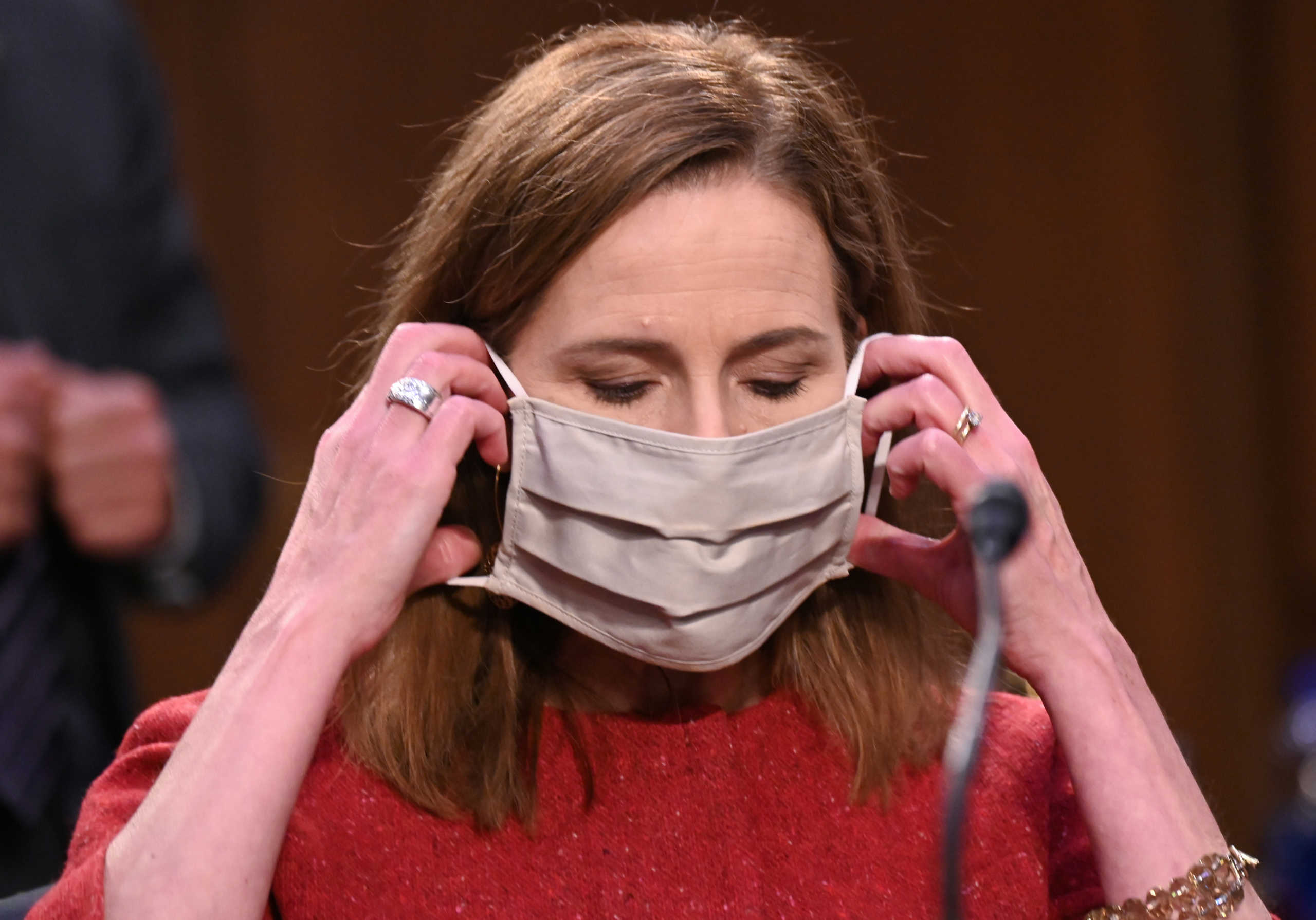 .S. Supreme Court nominee Judge Amy Coney Barrett puts on her face mask after testifying on the second day of her U.S. Senate Judiciary Committee confirmation hearings on Capitol Hill in Washington, U.S., October 13, 2020. REUTERS
