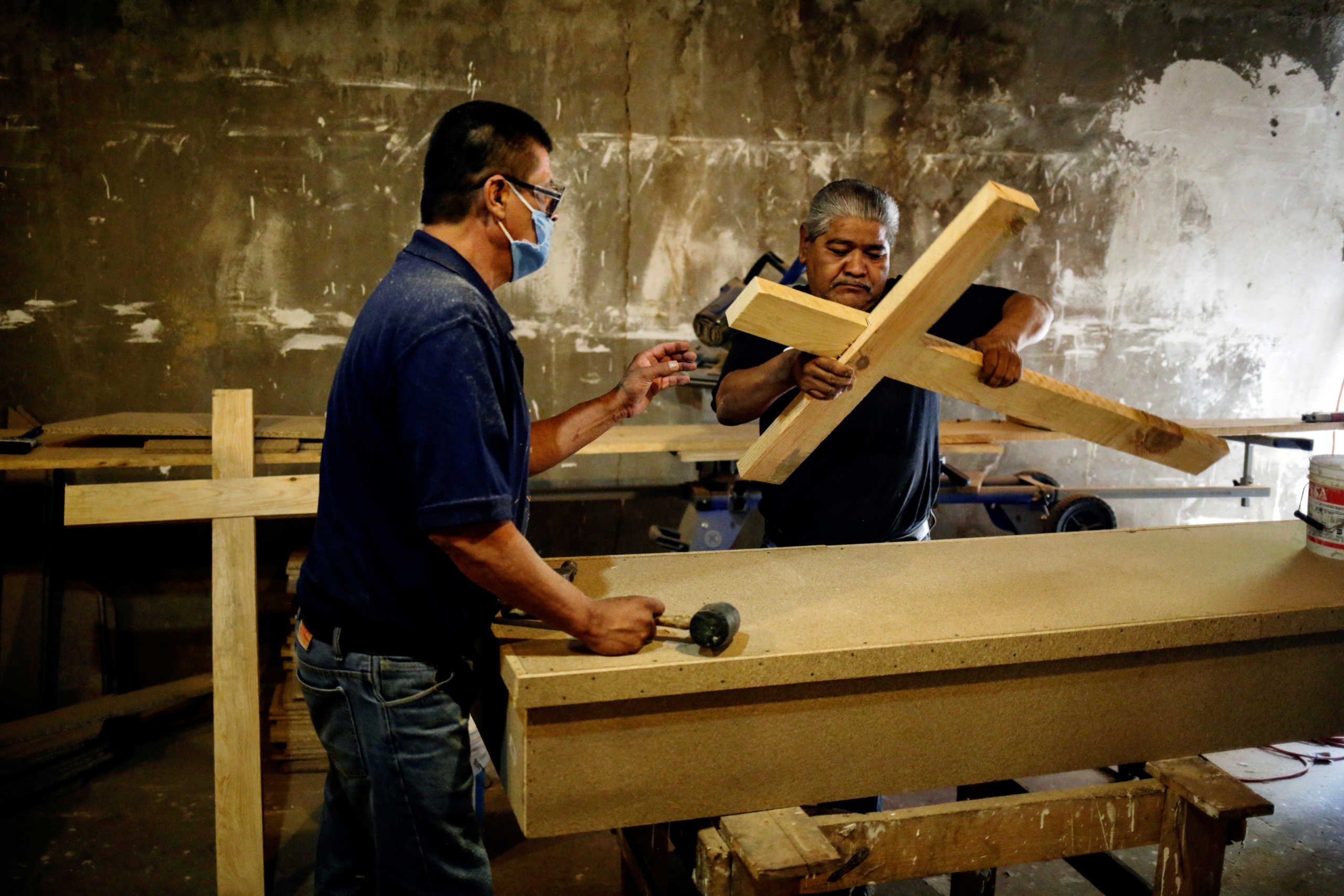Employees of the Rios funeral home make wooden crosses at a workshop to be used in burials, as the outbreak of the coronavirus disease (COVID-19) continues in Ciudad Juarez, Mexico October 7, 2020. REUTERS