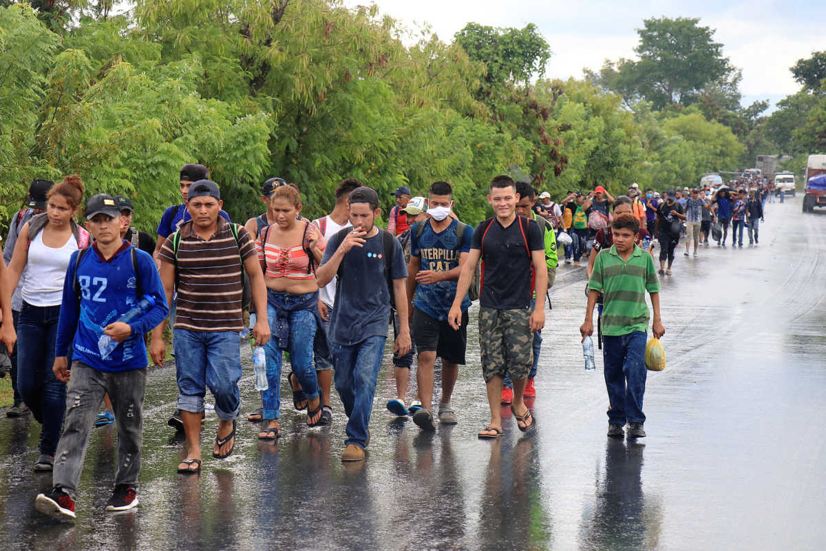 Honduran migrants trying to reach the U.S. walk along a road after bursting through a border checkpoint to enter Guatemala illegally, in Entre Rios, Guatemala October 1, 2020. REUTERS