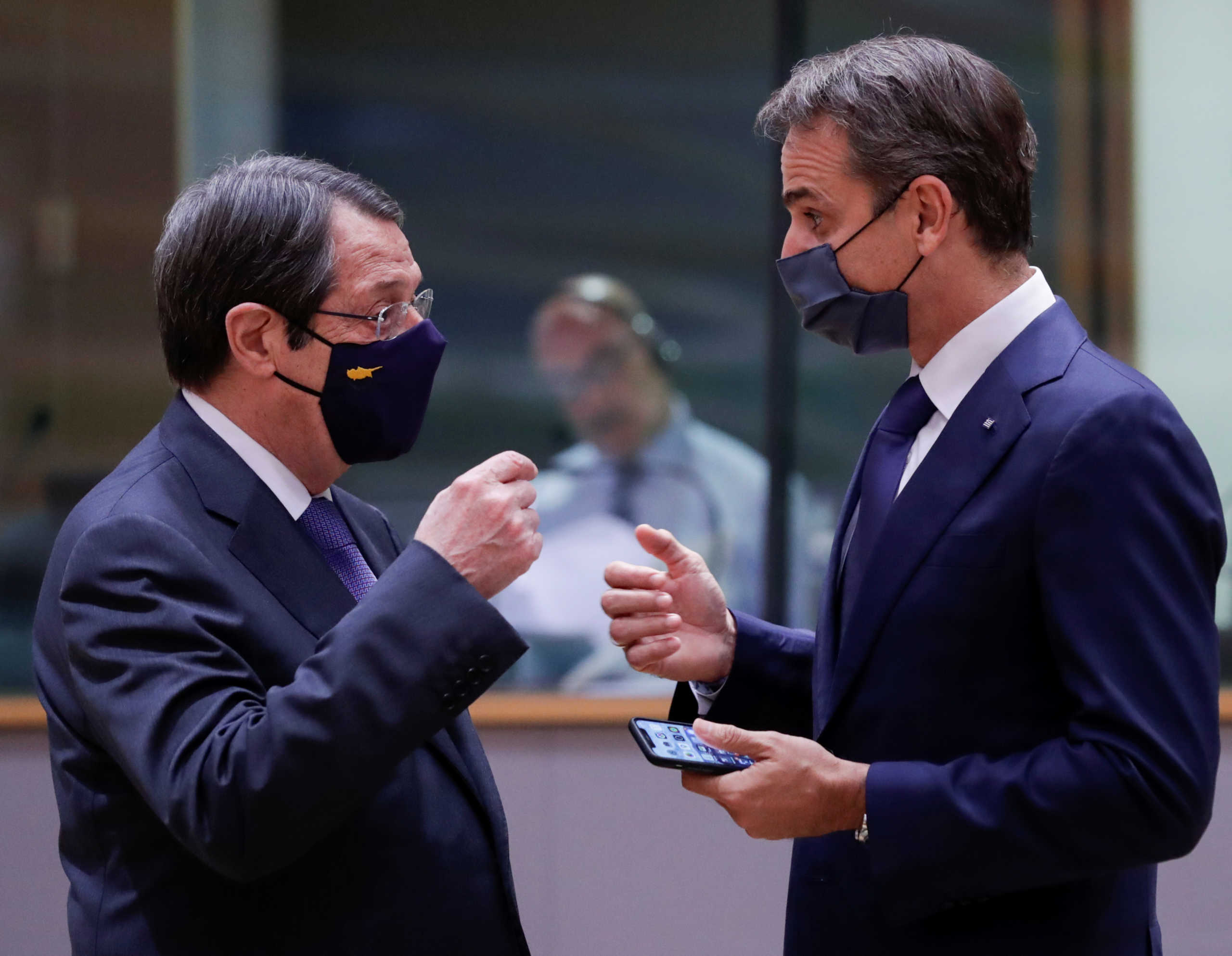 Greek Prime Minister Kyriakos Mitsotakis speaks with Cypriot President Nicos Anastasiades at the start of the second face-to-face European Union summit since the coronavirus disease (COVID-19) outbreak, in Brussels, Belgium October 1, 2020. Olivier Hoslet