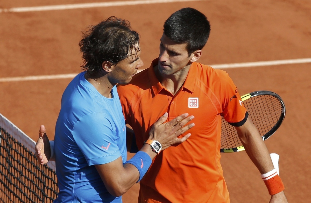 Novak Djokovic of Serbia (R) shakes hands with Rafael Nadal of Spain after winning their men's quarter-final match during the French Open tennis tournament at the Roland Garros stadium in Paris, France, June 3, 2015.          REUTERS
