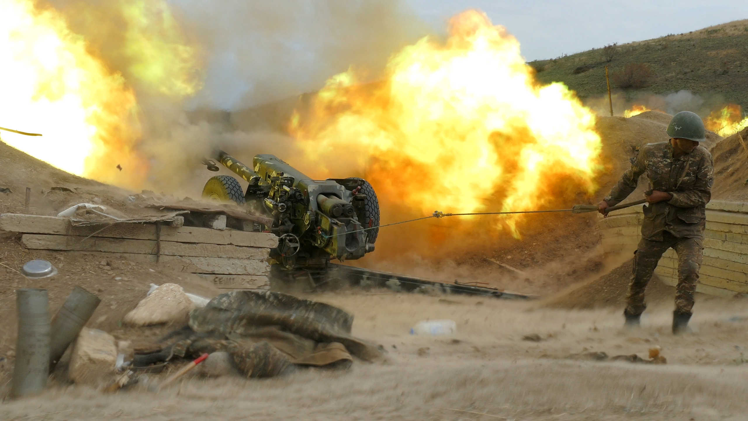 An ethnic Armenian soldier fires an artillery piece during a military conflict over the breakaway region of Nagorno-Karabakh, in this handout picture released October 5, 2020. Picture released October 5, 2020. Press office of Armenian Defense Ministry