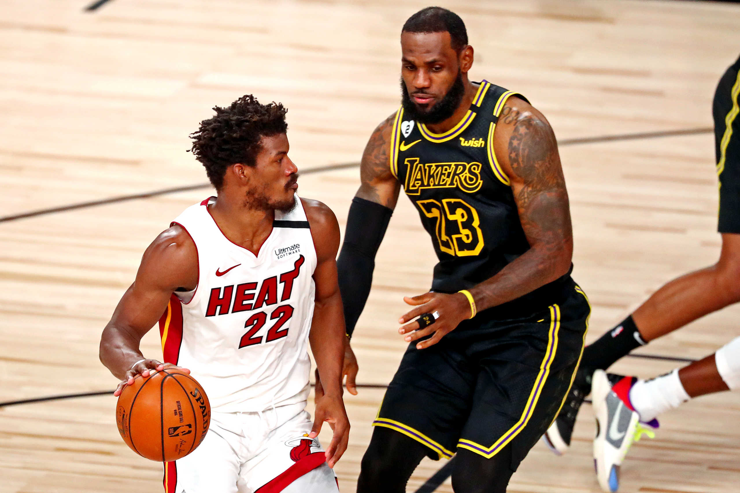 Oct 9, 2020; Lake Buena Vista, Florida, USA; Miami Heat forward Jimmy Butler (22) handles the ball against Los Angeles Lakers forward LeBron James (23) during the second quarter in game five of the 2020 NBA Finals at AdventHealth Arena. Mandatory Credit: Kim Klement-USA TODAY Sports
