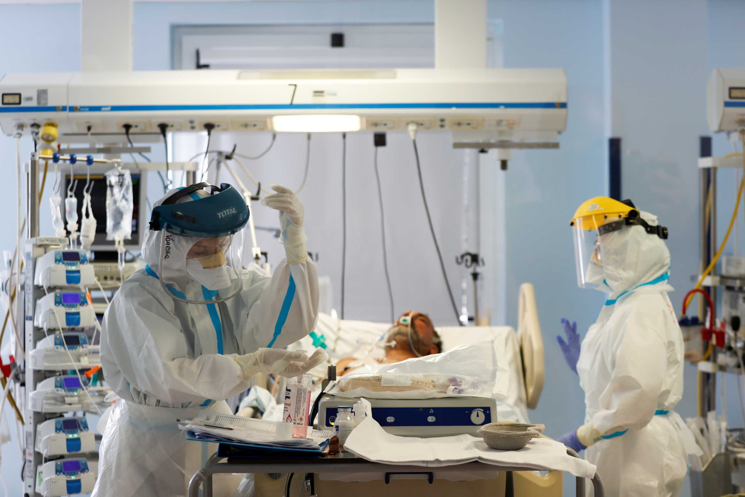 Medical workers in protective suits treat a patient suffering from the coronavirus disease (COVID-19) in an intensive care unit at the San Filippo Neri hospital in Rome, Italy, October 29, 2020. REUTERS