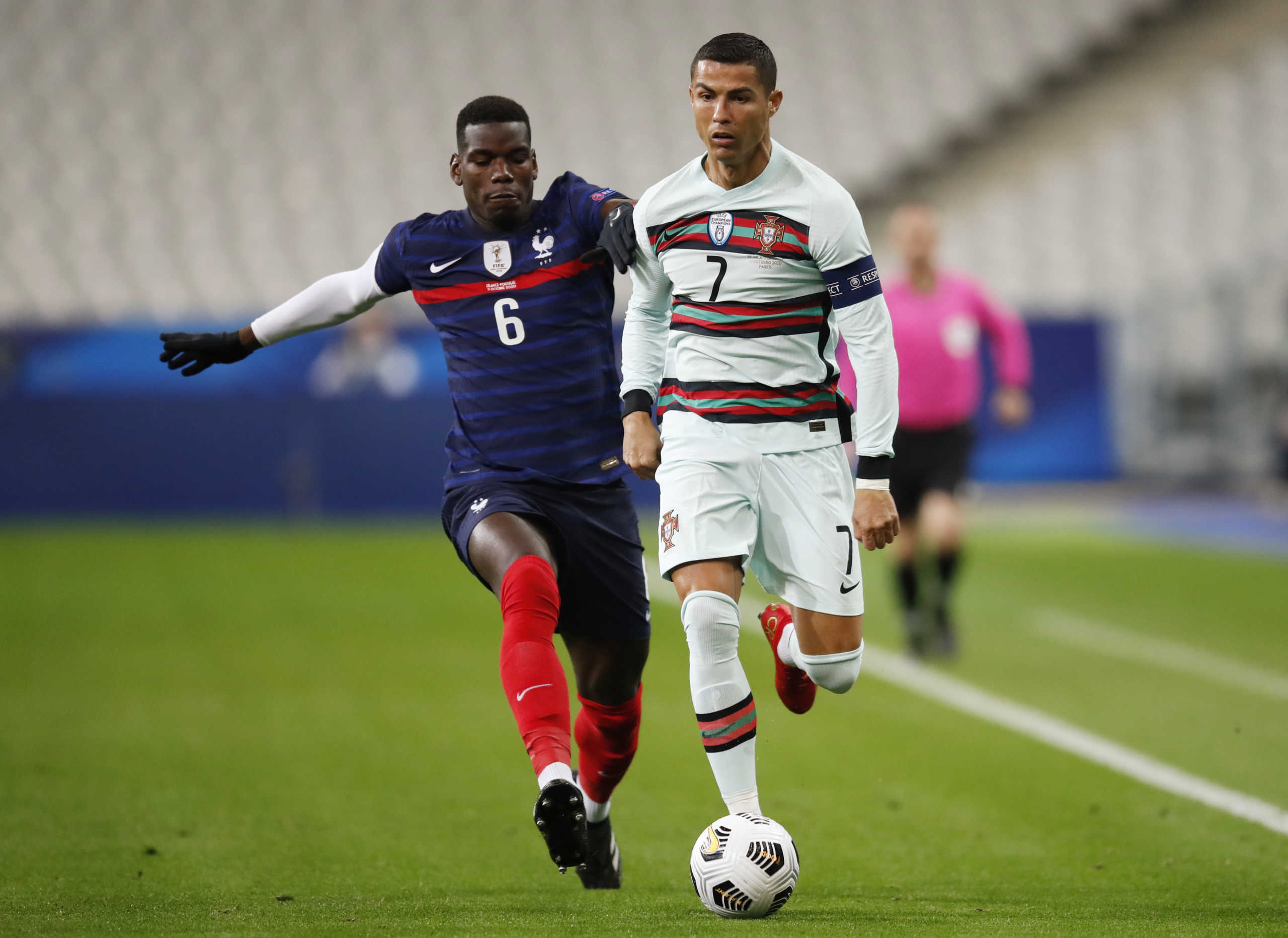 Soccer Football - UEFA Nations League - League A - Group 3 - France v Portugal - Stade De France, Paris, France - October 11, 2020 Portugal's Cristiano Ronaldo in action with France's Paul Pogba REUTERS