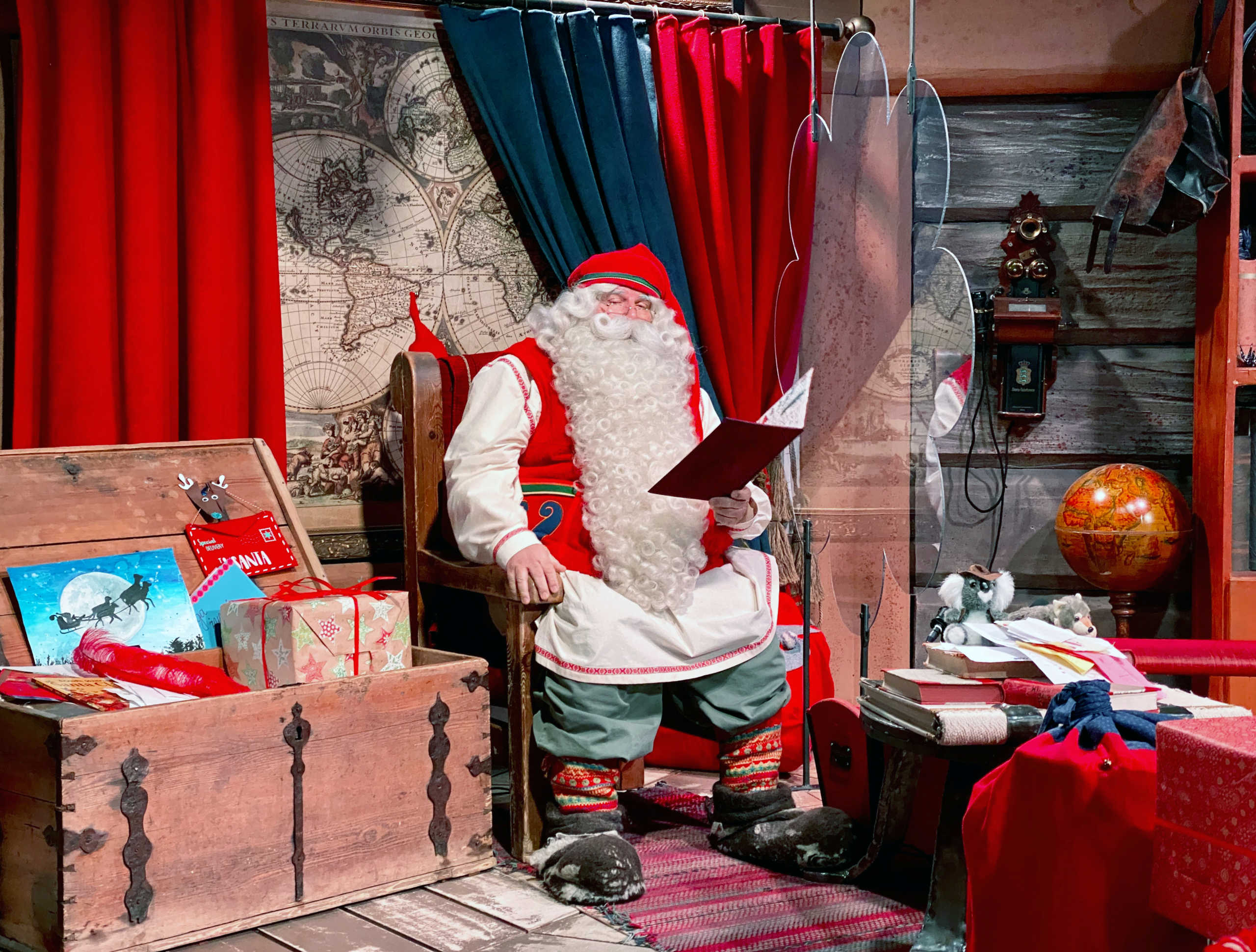 Santa Claus is pictured in his chamber behind a plexiglas screen at Santa Claus Village in the Arctic Circle near Rovaniemi, Finland October 13, 2020. Normally Santa's village in northern Finland is bustling with visitors in the months before Christmas but this year the pandemic has made them stay away, plunging the tourist attraction into crisis. Picture taken October 13, 2020.  REUTERS