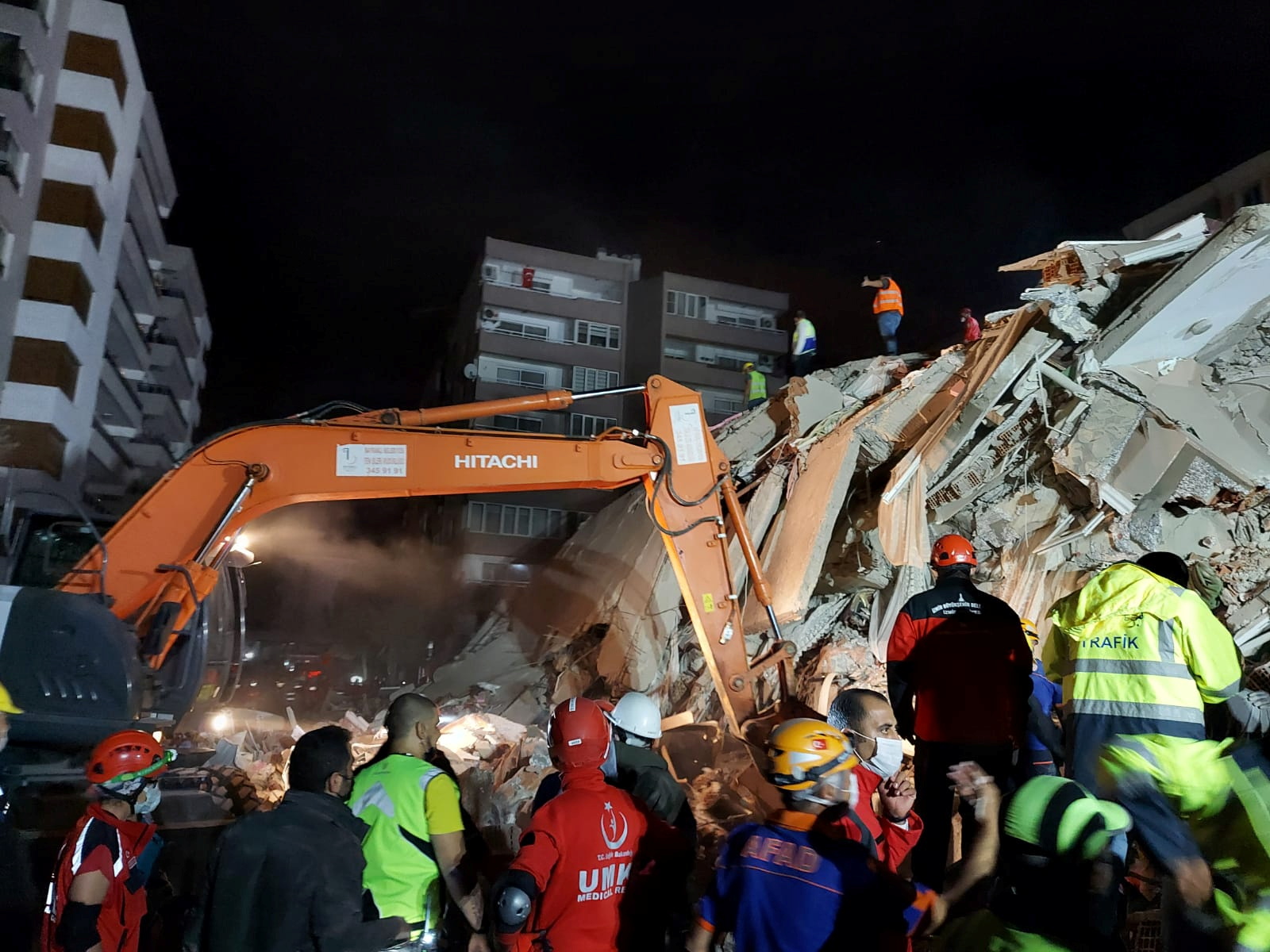 Rescque teams search for survivors at a collapsed building after a strong earthquake struck the Aegean Sea where some buildings collapsed in the coastal province of Izmir, Turkey, October 30, 2020. REUTERS
