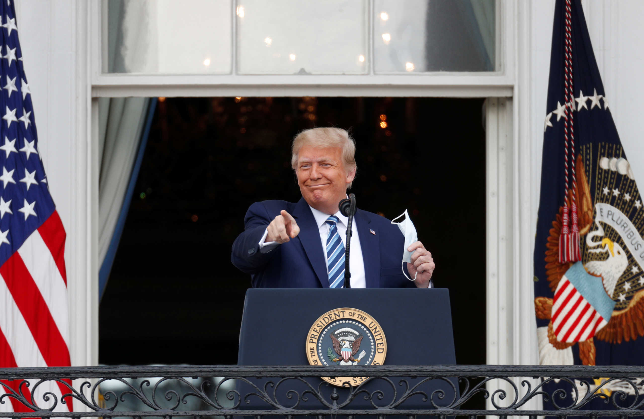 U.S. President Donald Trump gestures as he stands on a White House balcony speaking to supporters gathered on the South Lawn for a campaign rally that the White House is calling a "peaceful protest" in Washington, U.S., October 10, 2020. REUTERS