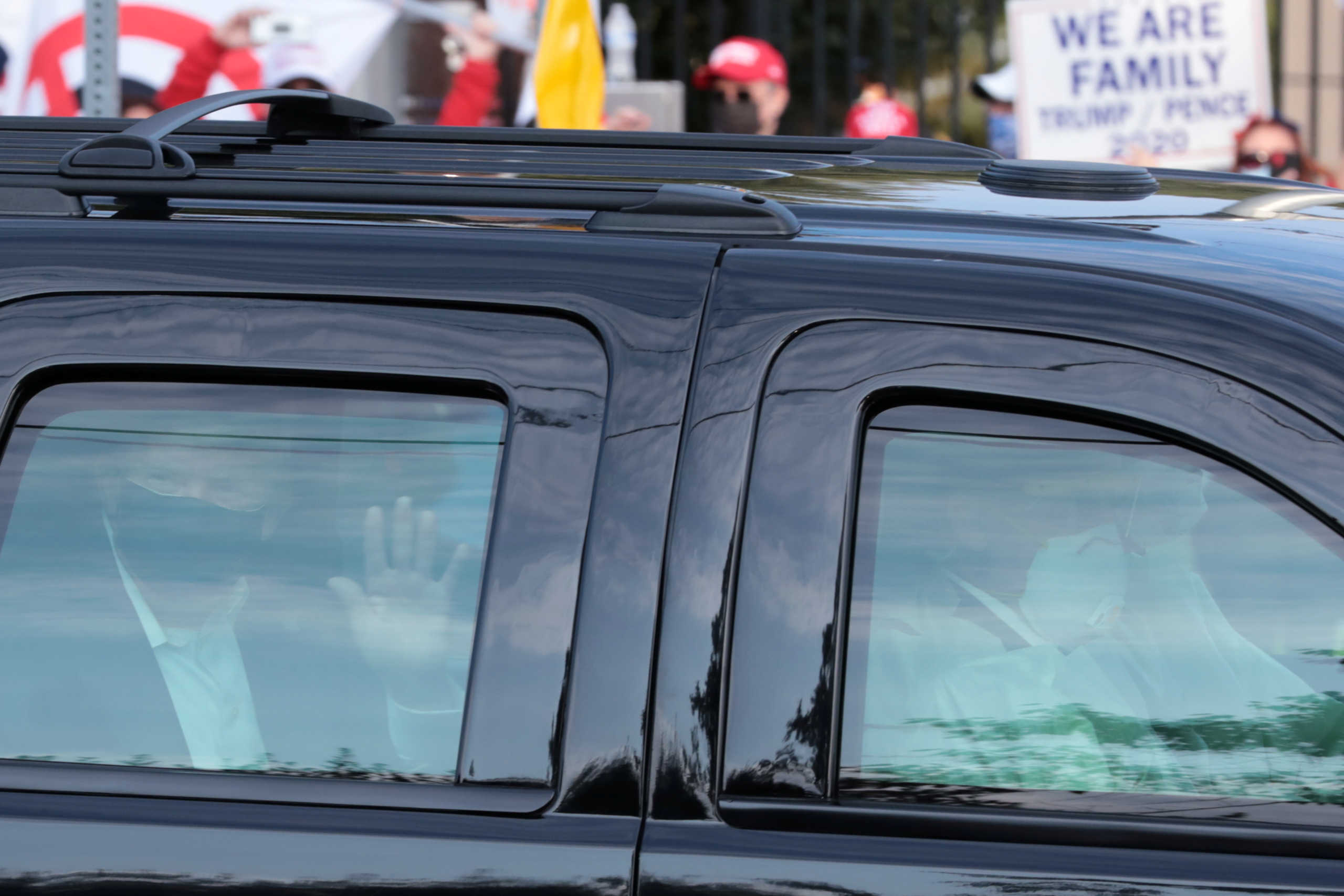 U.S. President Donald Trump rides in front of  the Walter Reed National Military Medical Center, where he is being treated for the coronavirus disease (COVID-19) in Bethesda, Maryland, U.S. October 4, 2020.  REUTERS