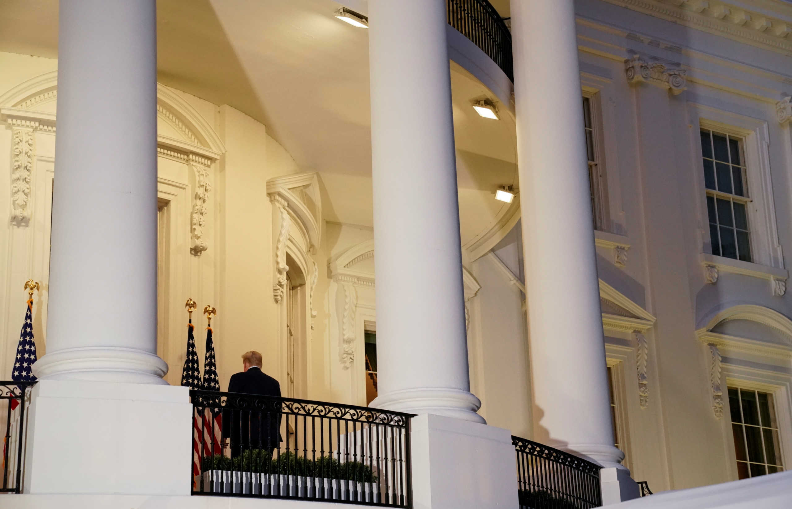 U.S. President Donald Trump stops and poses without a face mask for a White House staff photographer on the Truman Balcony of the White House as he returns from being hospitalized at Walter Reed Medical Center for coronavirus disease (COVID-19) treatment, in Washington, U.S. October 5, 2020. REUTERS