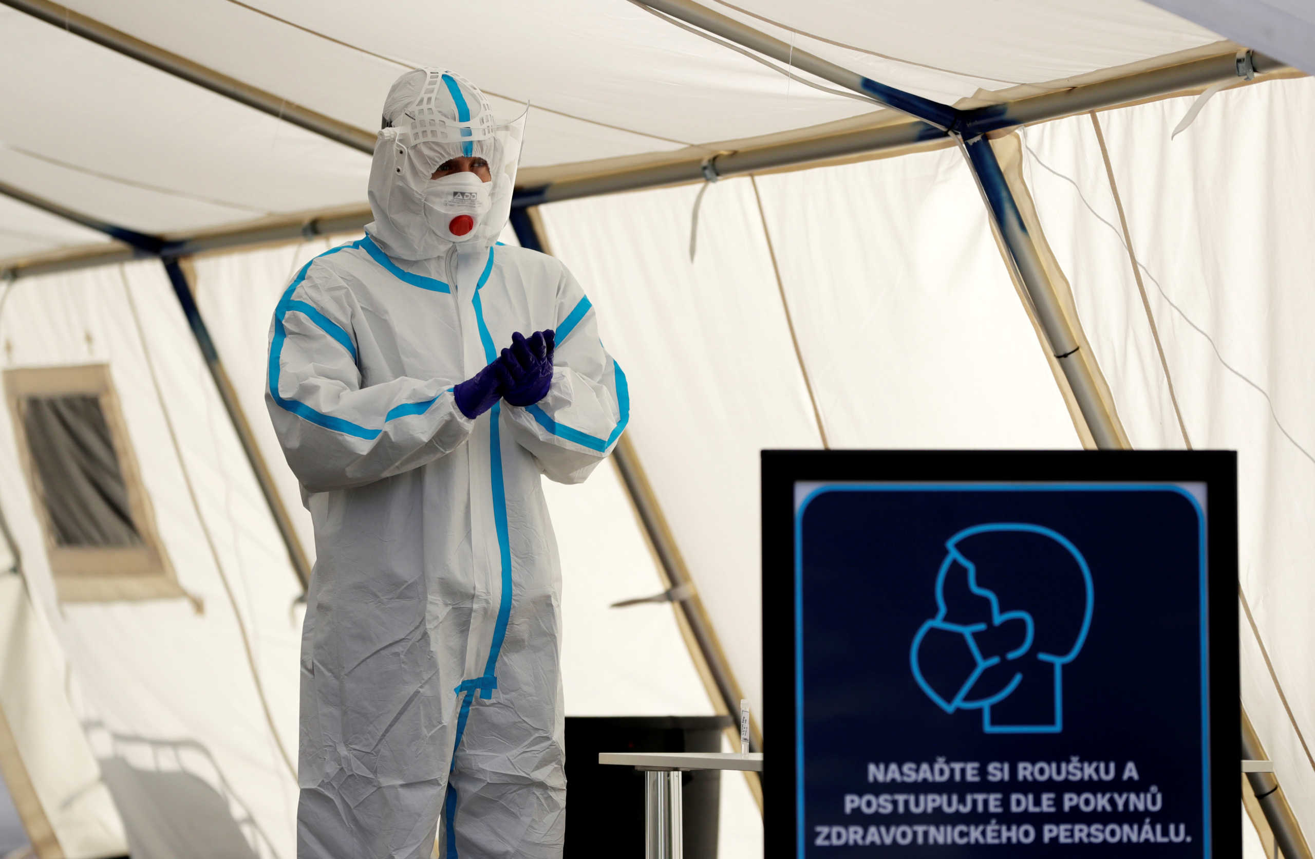 A medical staff member wearing a protective suit prepares for people who will be tested for the coronavirus disease (COVID-19) at a newly opened drive-in sampling station in Prague, Czech Republic, October 7, 2020. REUTERS