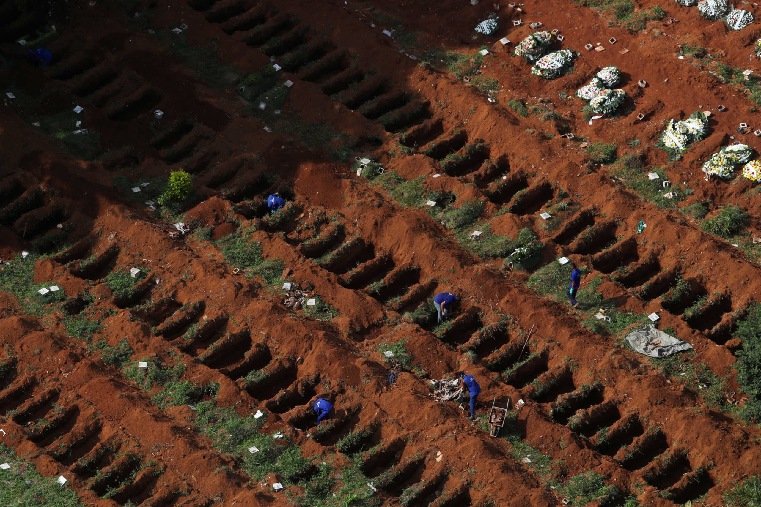 FILE PHOTO: Gravediggers open new graves as the number of dead rose amid the coronavirus outbreak, at Vila Formosa cemetery, Brazil's biggest cemetery, in Sao Paulo, April 2. REUTERS