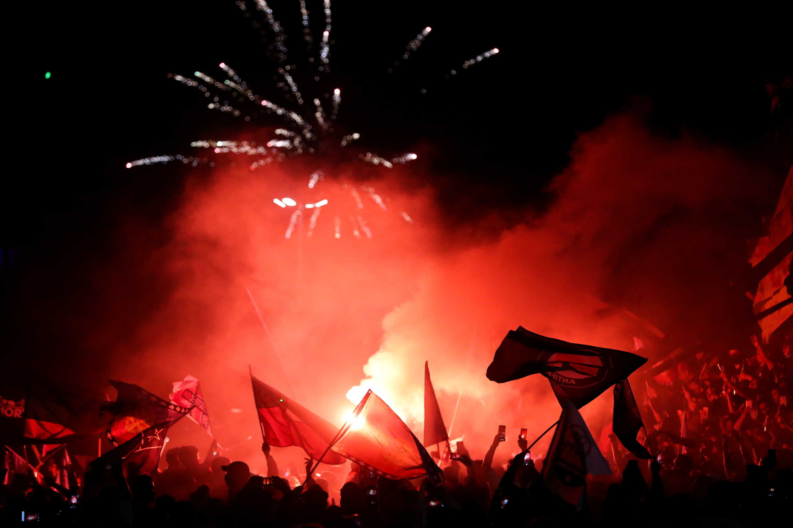 People light flares and hold flags as they gather to protest against Chile's government during a referendum on a new Chilean constitution in Santiago, Chile, October 25, 2020. REUTERS